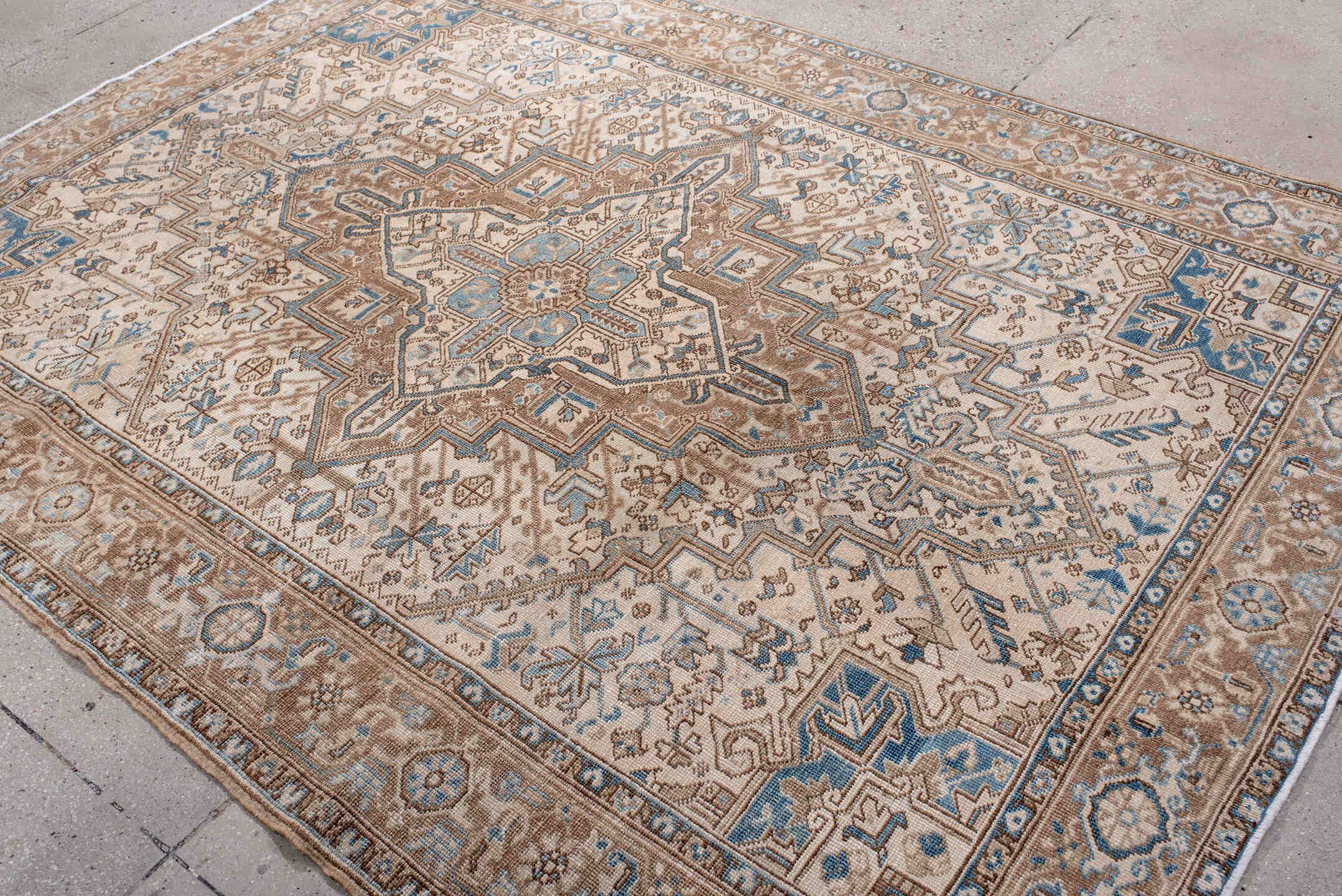 6' x 8' one-of-a-kind handmade antique Heriz medium size rug. Color palette: ivory, taupe, sky blue, camel, brown, beige