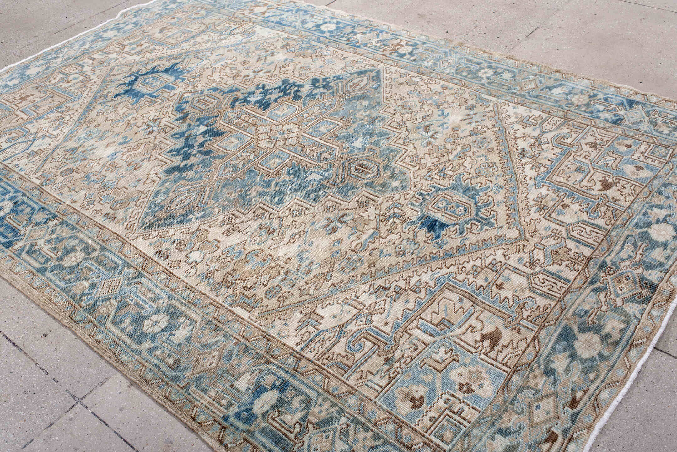 6' x 9' one-of-a-kind handmade antique Heriz medium size rug. Color palette: ivory, sky blue, denim blue, taupe, beige