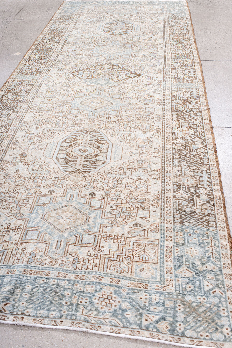 5' x 12' one-of-a-kind handmade antique Karaje runner rug. Color palette: ivory, pale blue, taupe, camel, light brown