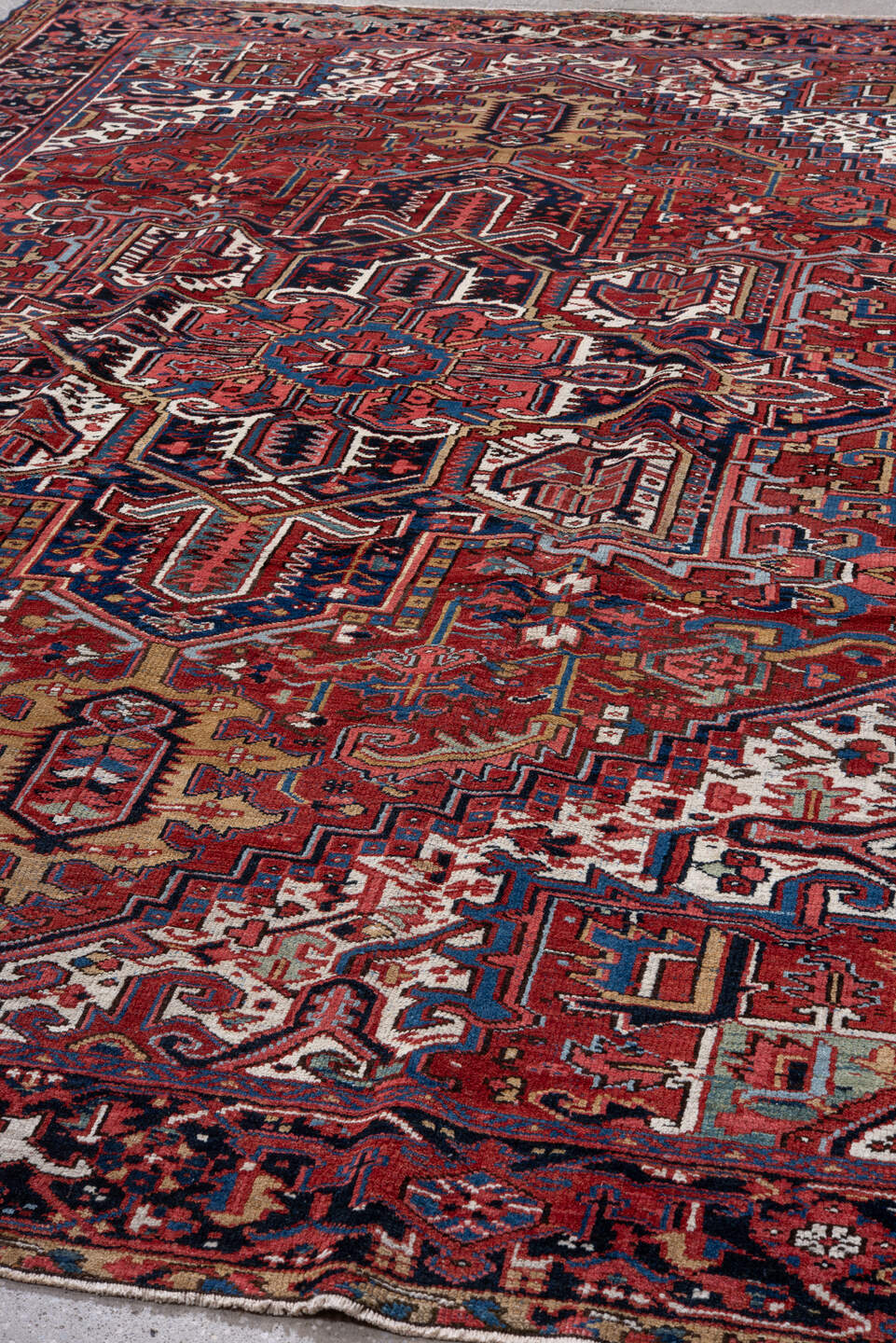 7' x 10' one-of-a-kind handmade vintage Heriz large size rug. Color palette: rust, navy, ivory, crimson, cobalt, camel, rose