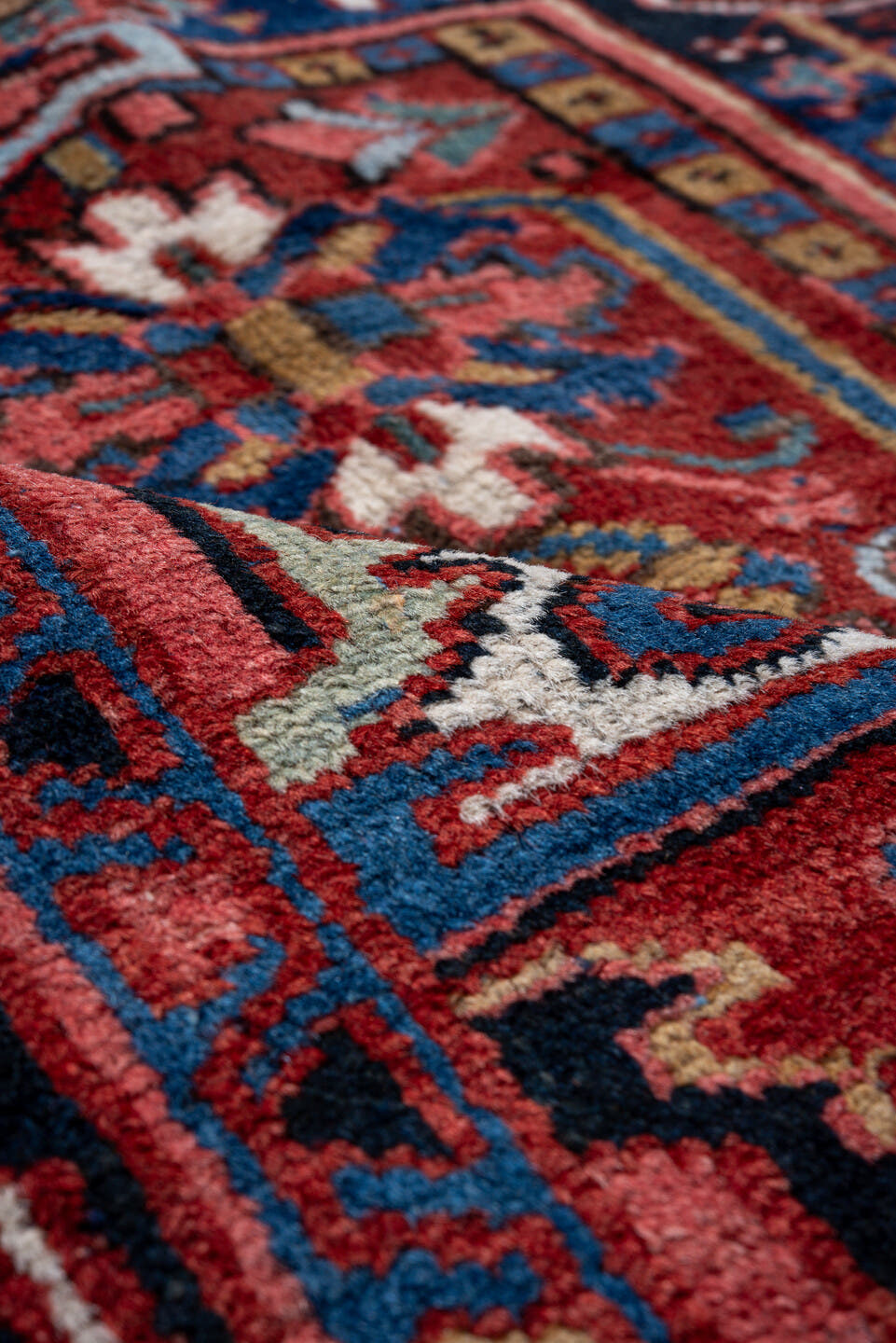7' x 10' one-of-a-kind handmade vintage Heriz large size rug. Color palette: rust, navy, ivory, crimson, cobalt, camel, rose