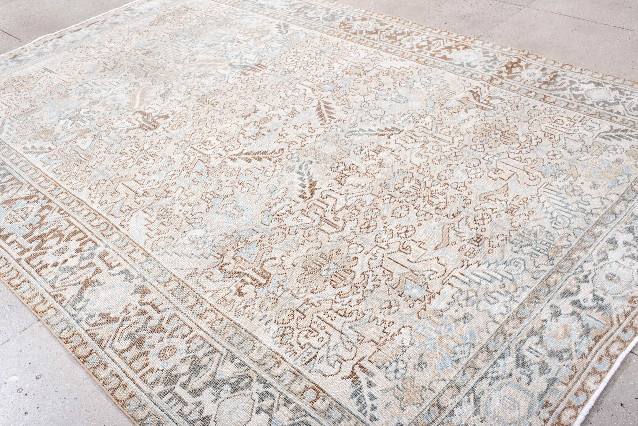 7' x 11' one-of-a-kind handmade antique Heriz large size rug. Color palette: ivory, taupe, light blue, camel, brown, cream