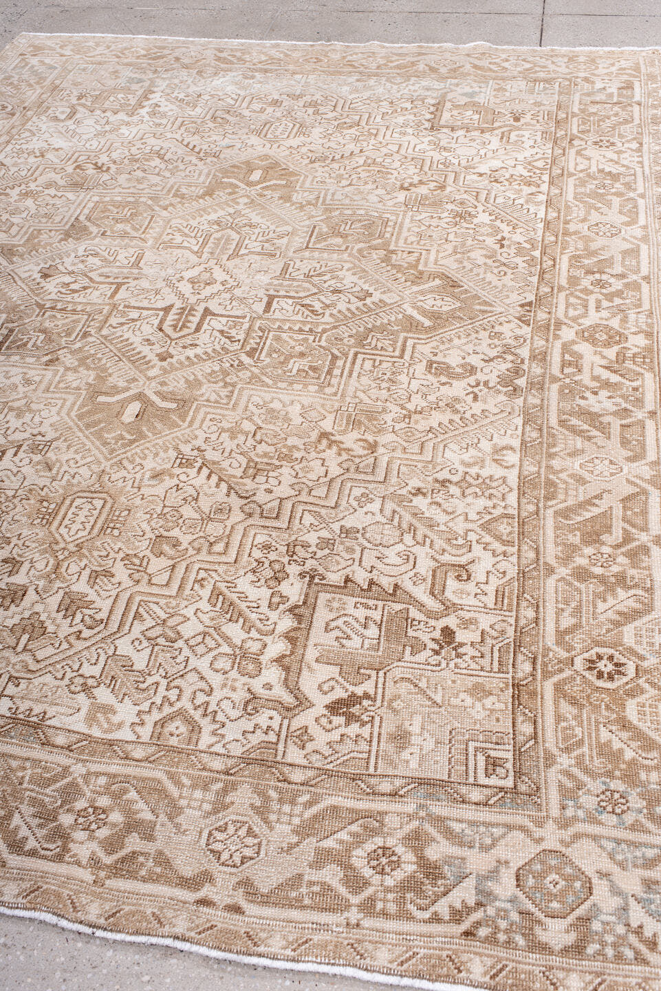 7' x 9' one-of-a-kind handmade antique Heriz rug. Color palette: ivory, camel, taupe, beige, sand, gray