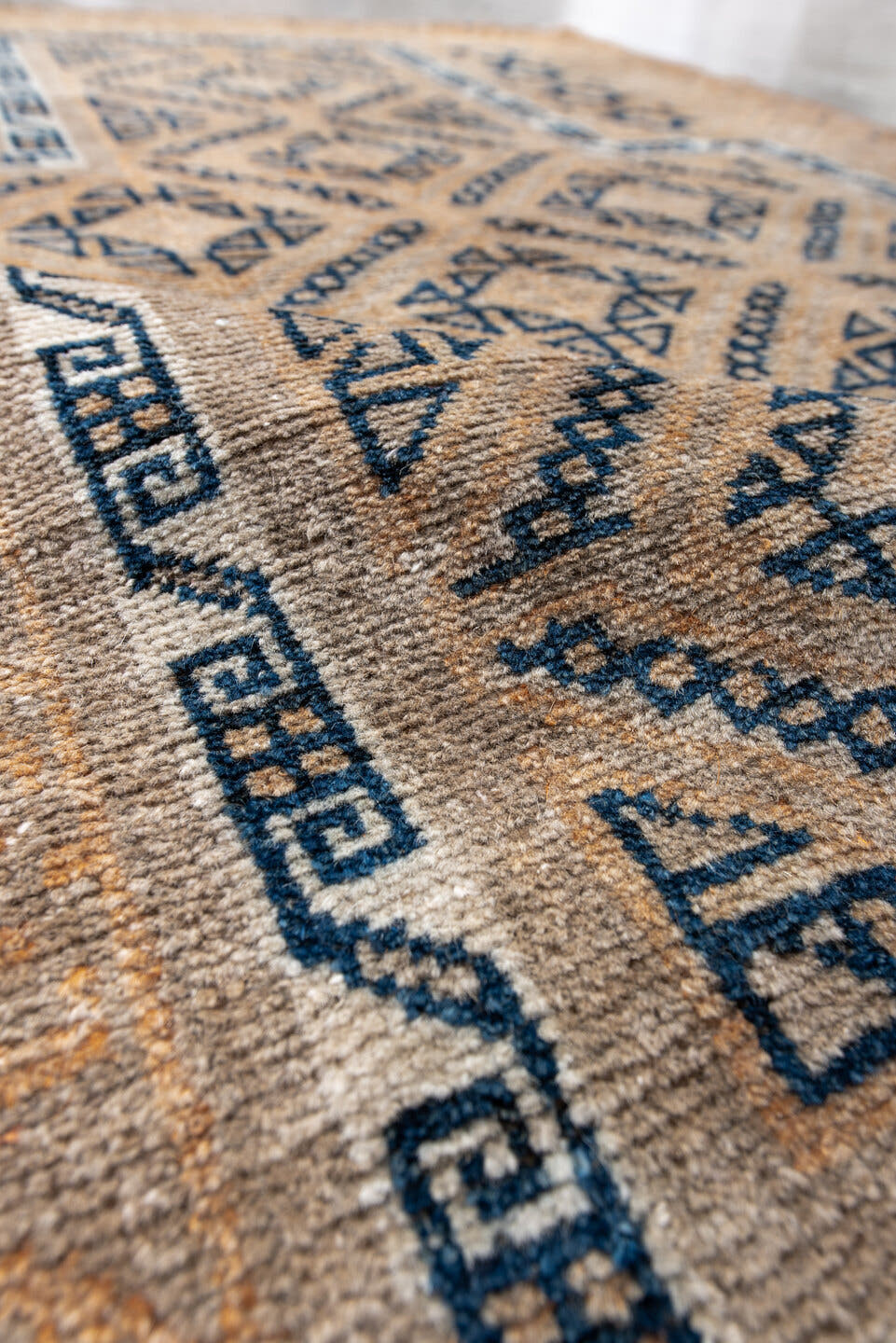 3' x 5' one-of-a-kind handmade antique Belouch small size rug. Color palette: camel, indigo, ivory, taupe, sand, beige