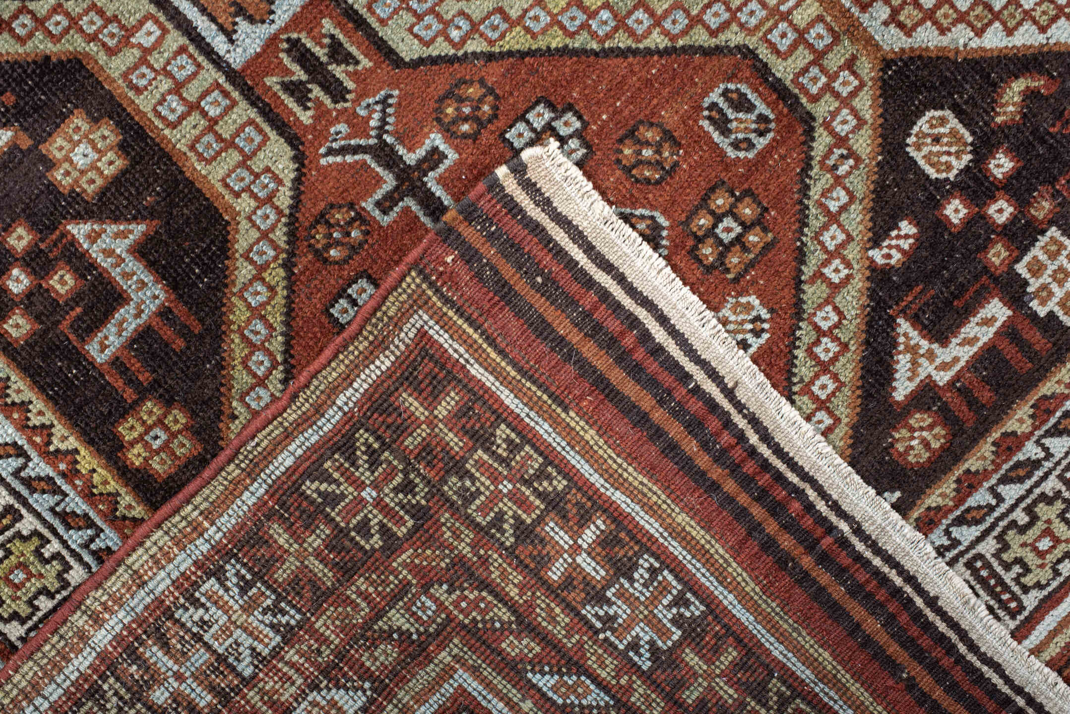 4' x 6' one-of-a-kind handmade antique Belouch small size rug. Color palette: rust, ivory, dark brown, sky blue, sage