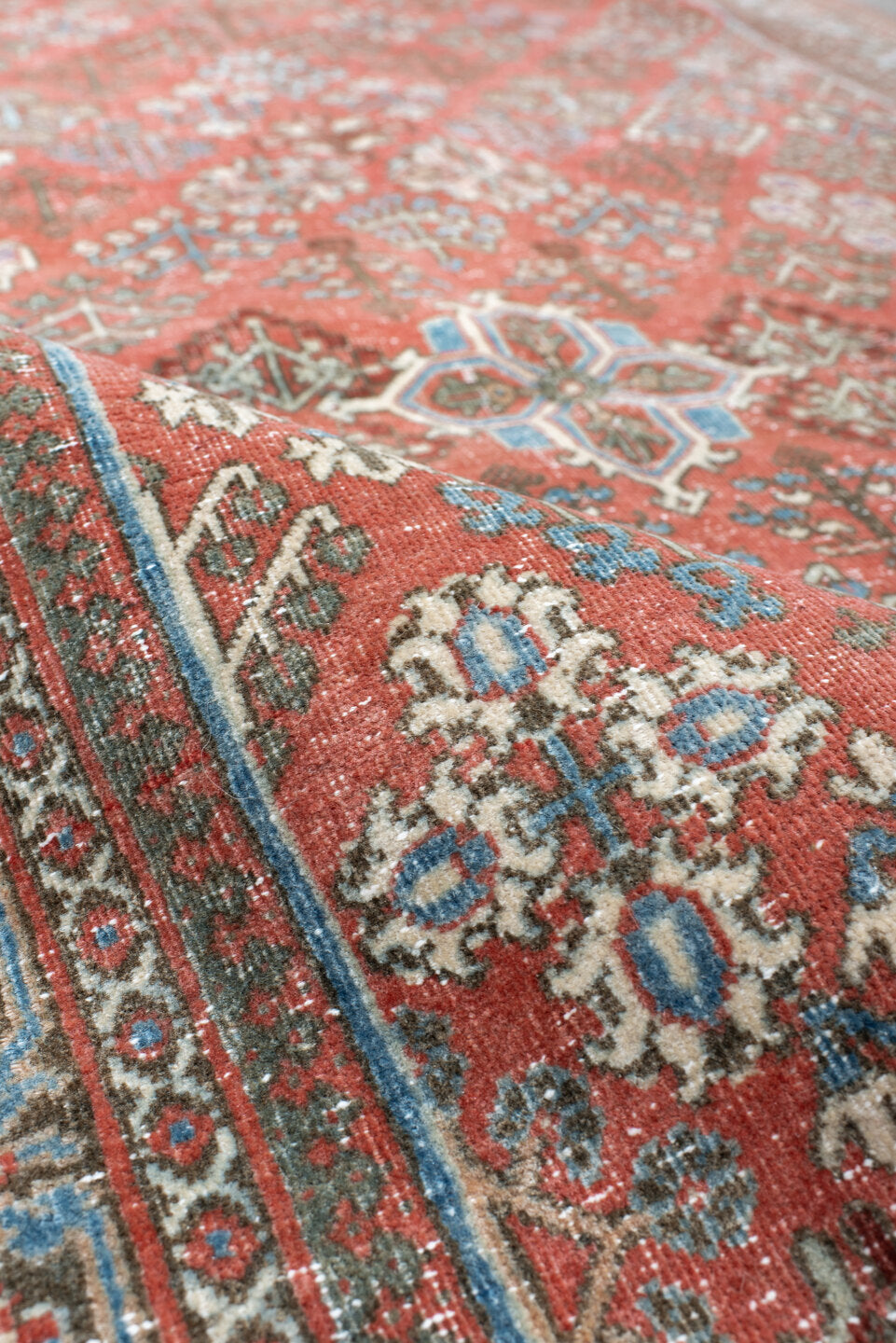 4' x 6' one-of-a-kind handmade vintage Joshegan rug. Color palette: terracotta, pale blue, ivory, slate, taupe, rust