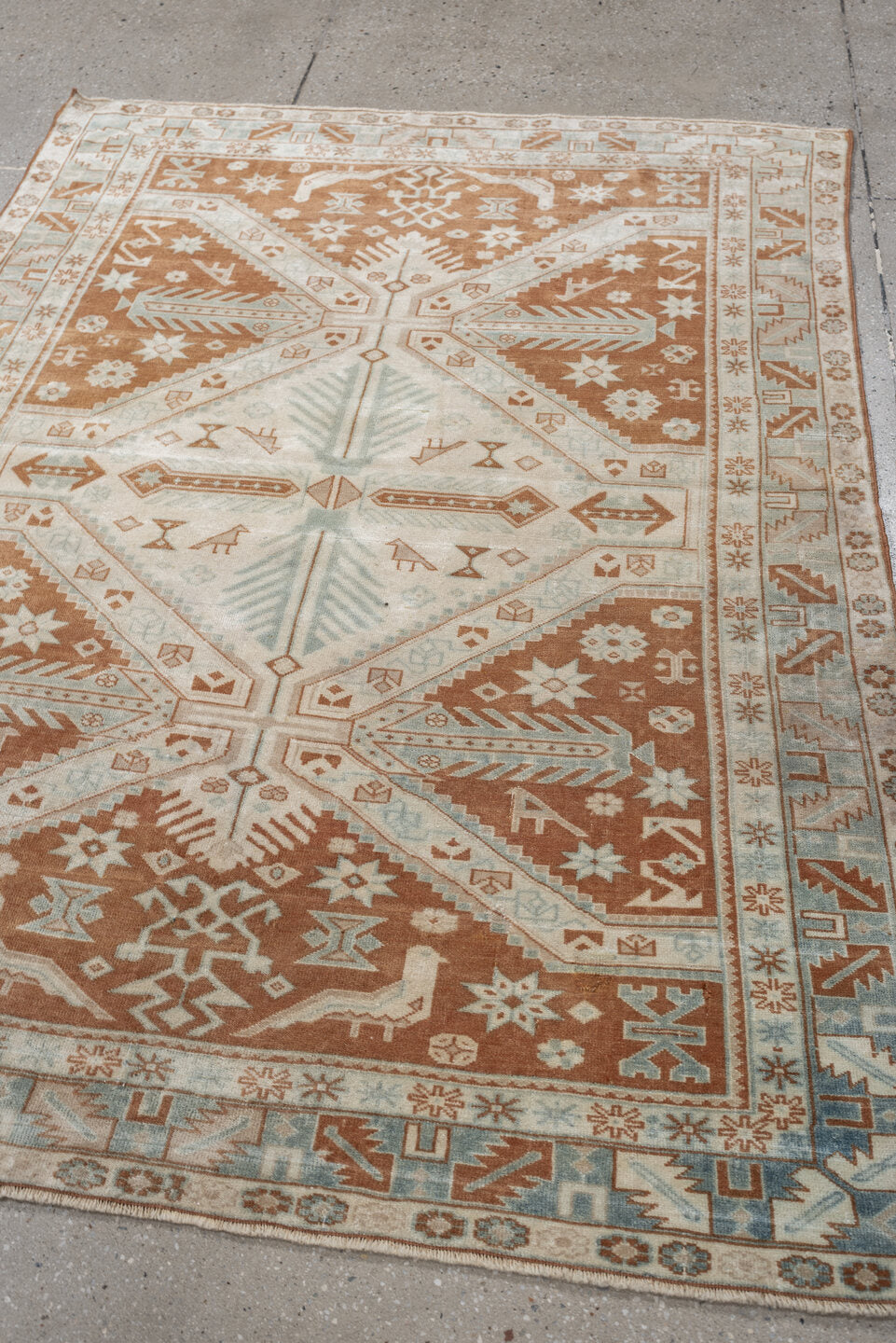 4' x 5' one-of-a-kind handmade antique Caucasian small size rug. Color palette: terra cotta, ivory, pale blue, camel, taupe