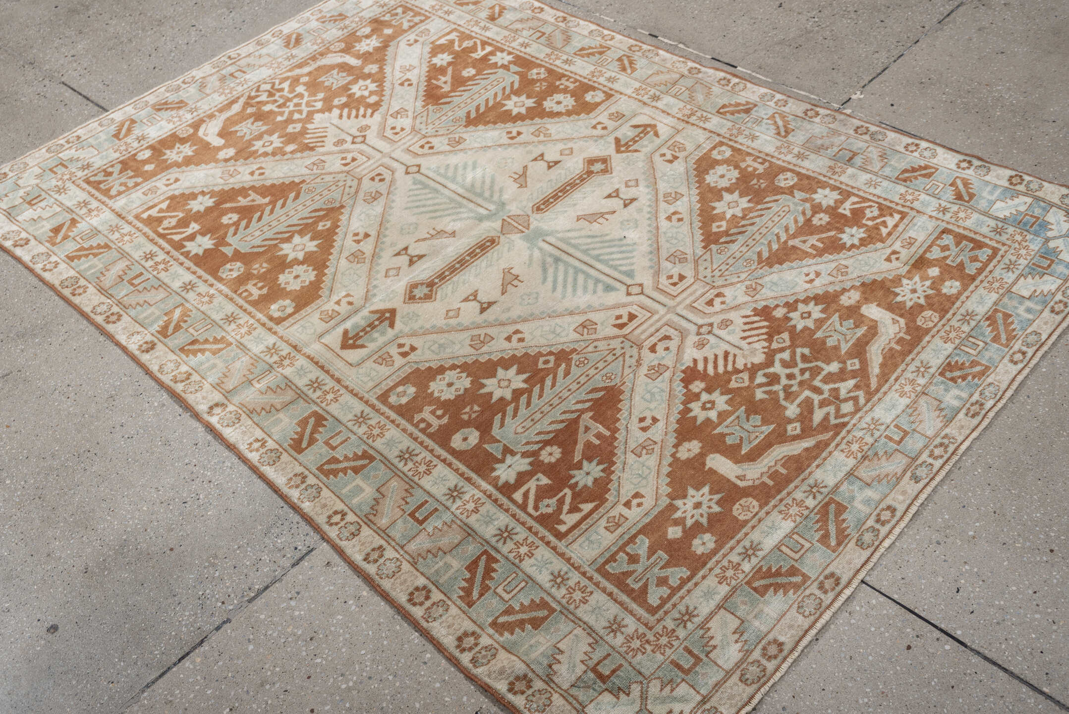 4' x 5' one-of-a-kind handmade antique Caucasian small size rug. Color palette: terra cotta, ivory, pale blue, camel, taupe