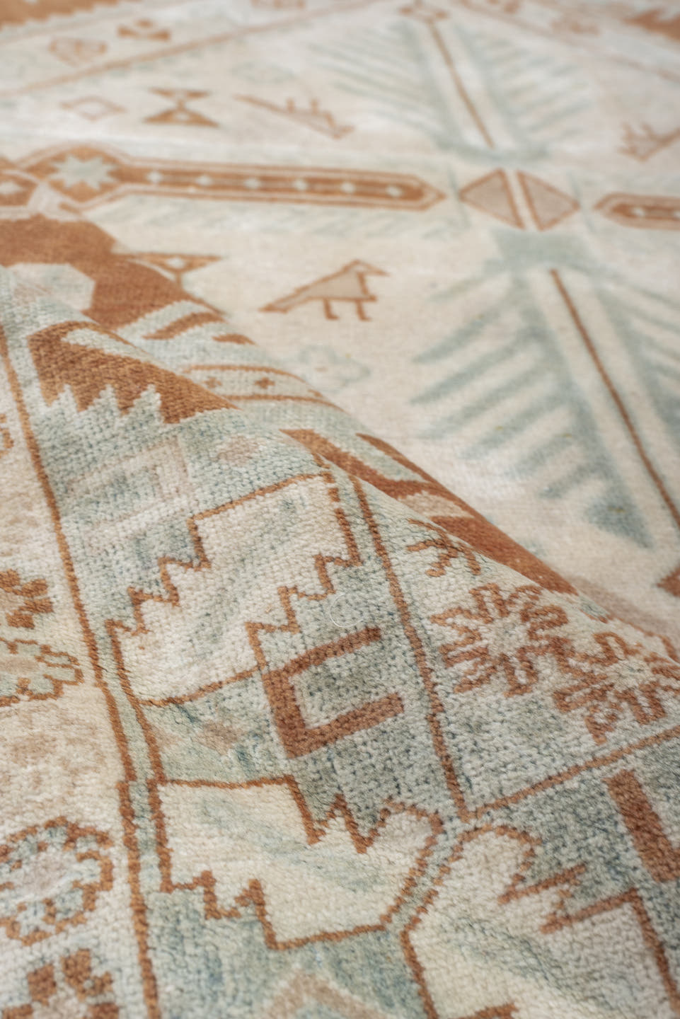 4' x 5' one-of-a-kind handmade antique Caucasian small size rug. Color palette: terra cotta, ivory, pale blue, camel, taupe