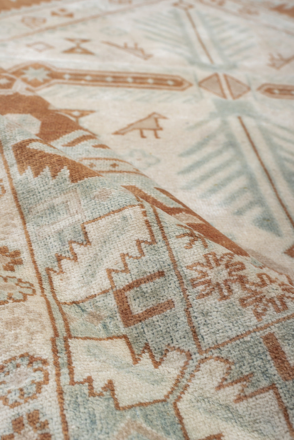 4' x 5' one-of-a-kind handmade antique Caucasian small size rug. Color palette: terra cotta, ivory, pale blue, camel, taupe