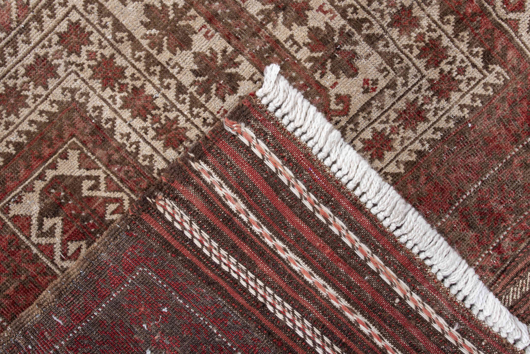 3' x 5' one-of-a-kind handmade antique Belouch small size rug. Color palette: rust, ivory, brown, burgundy, taupe, camel
