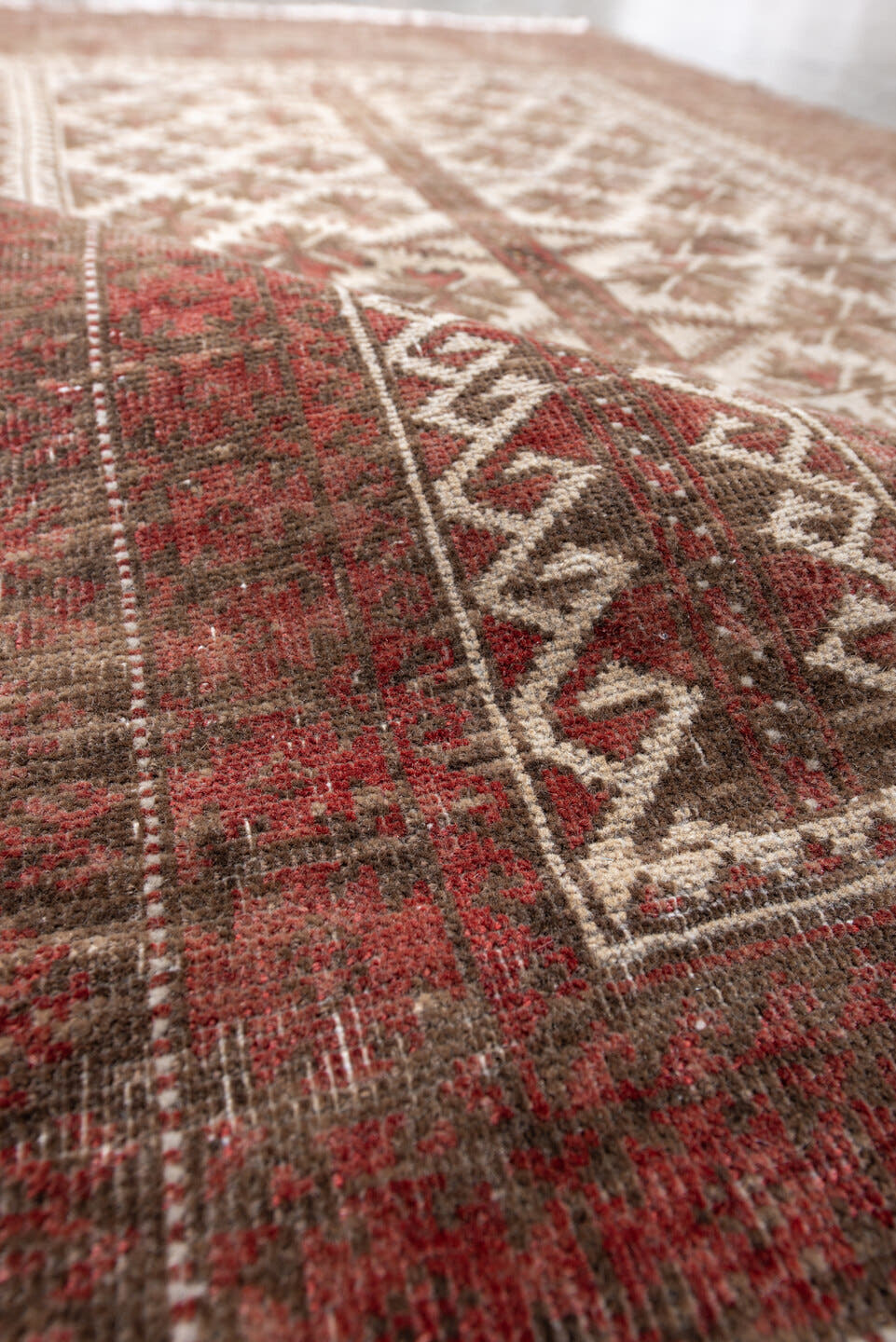 3' x 5' one-of-a-kind handmade antique Belouch small size rug. Color palette: rust, ivory, brown, burgundy, taupe, camel