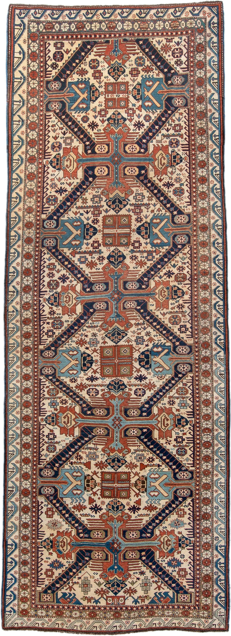 4' x 11' one-of-a-kind handmade antique Caucasian runner rug. Color palette: ivory, indigo, rust, sky blue, navy, camel