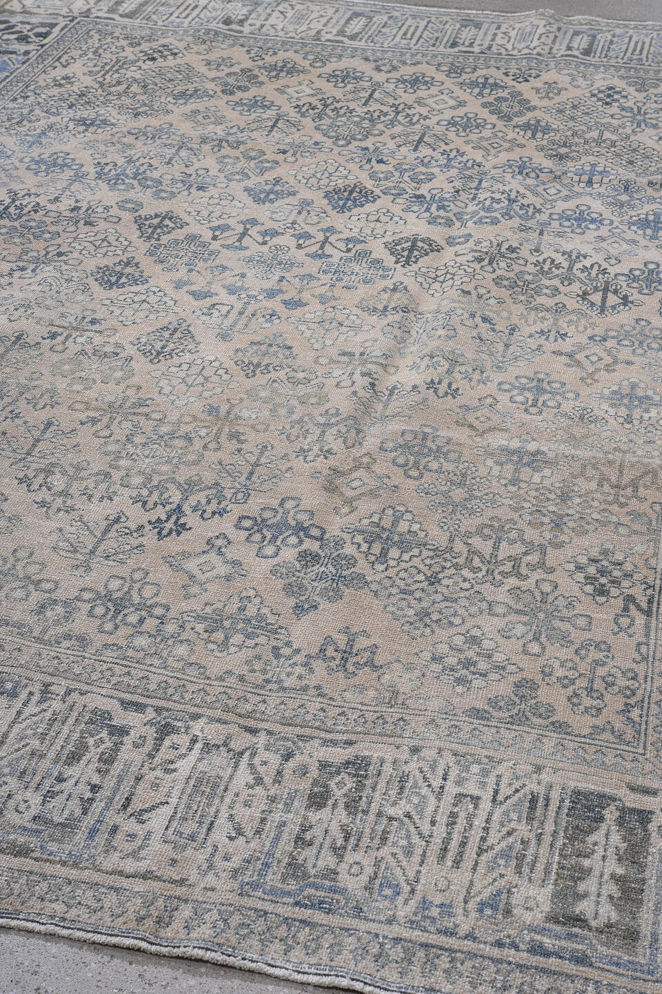 7' x 10' one-of-a-kind handmade antique Joshegan large size rug. Color palette: ivory, blue, slate, taupe, cream, gray