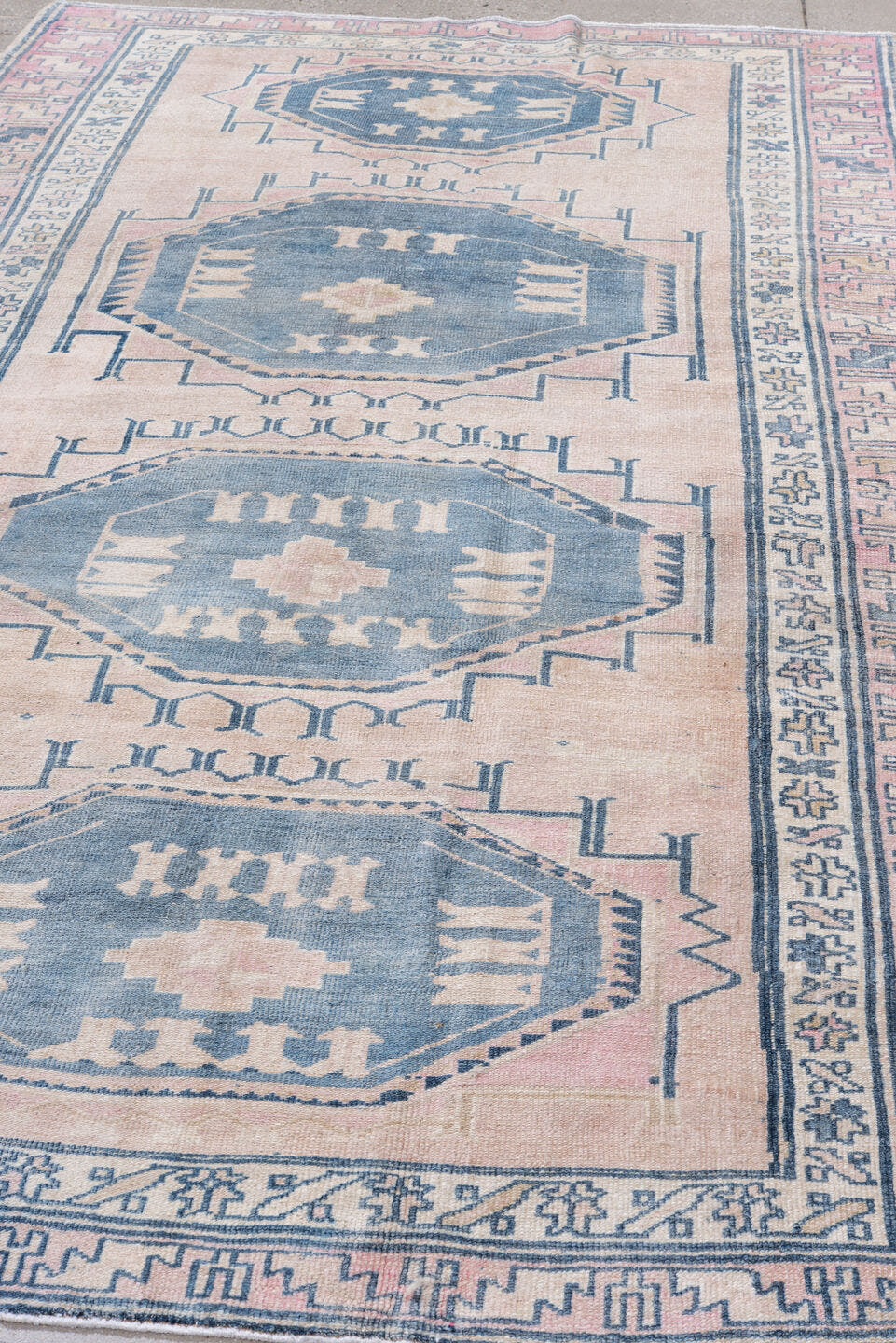 5' x 9' one-of-a-kind handmade antique Caucasian medium size rug. Color palette: blush, blue, ivory, navy, rose, cream, pink