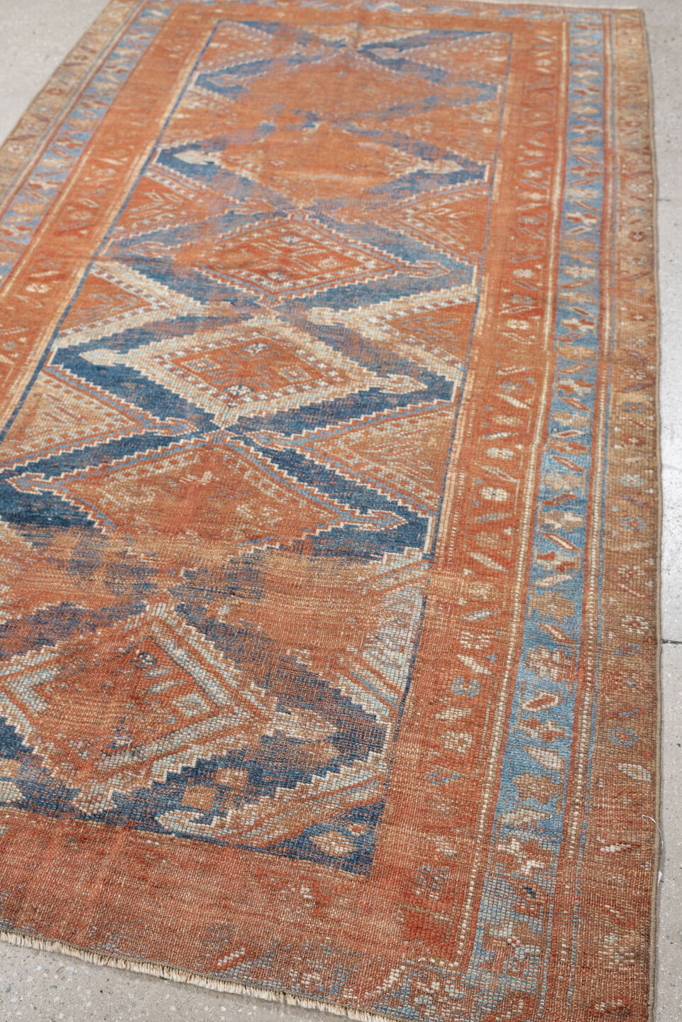 4' x 7' one-of-a-kind handmade antique Kurd rug. Color palette: terracotta, powder blue, ivory, camel, taupe, rust, brown