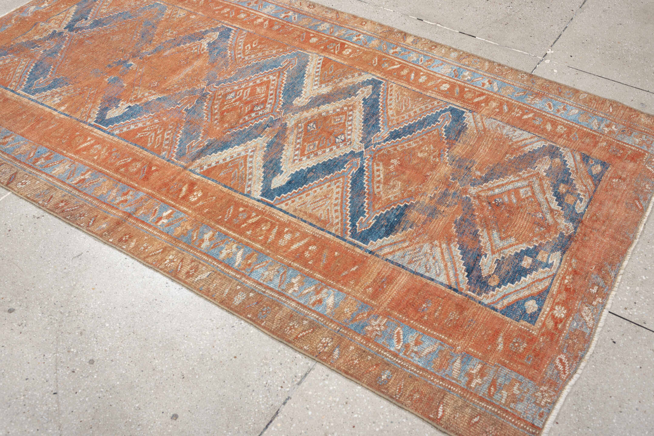 4' x 7' one-of-a-kind handmade antique Kurd rug. Color palette: terracotta, powder blue, ivory, camel, taupe, rust, brown