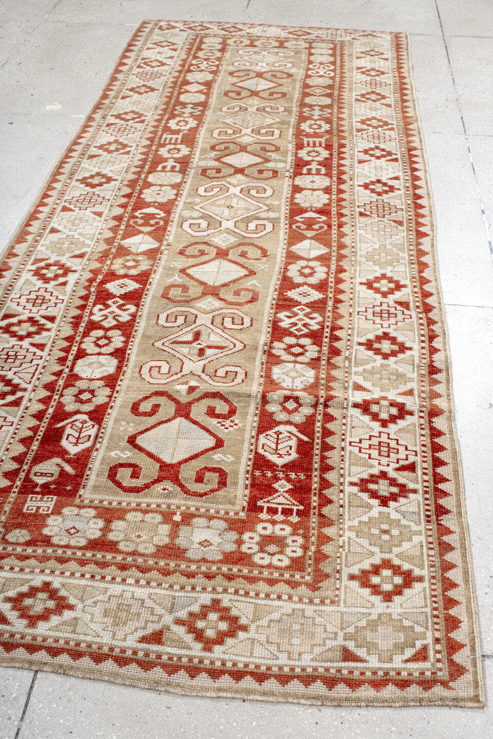 4' x 9' one-of-a-kind handmade antique Caucasian runner rug. Color palette: ivory, rust, camel, brick, beige, terracotta