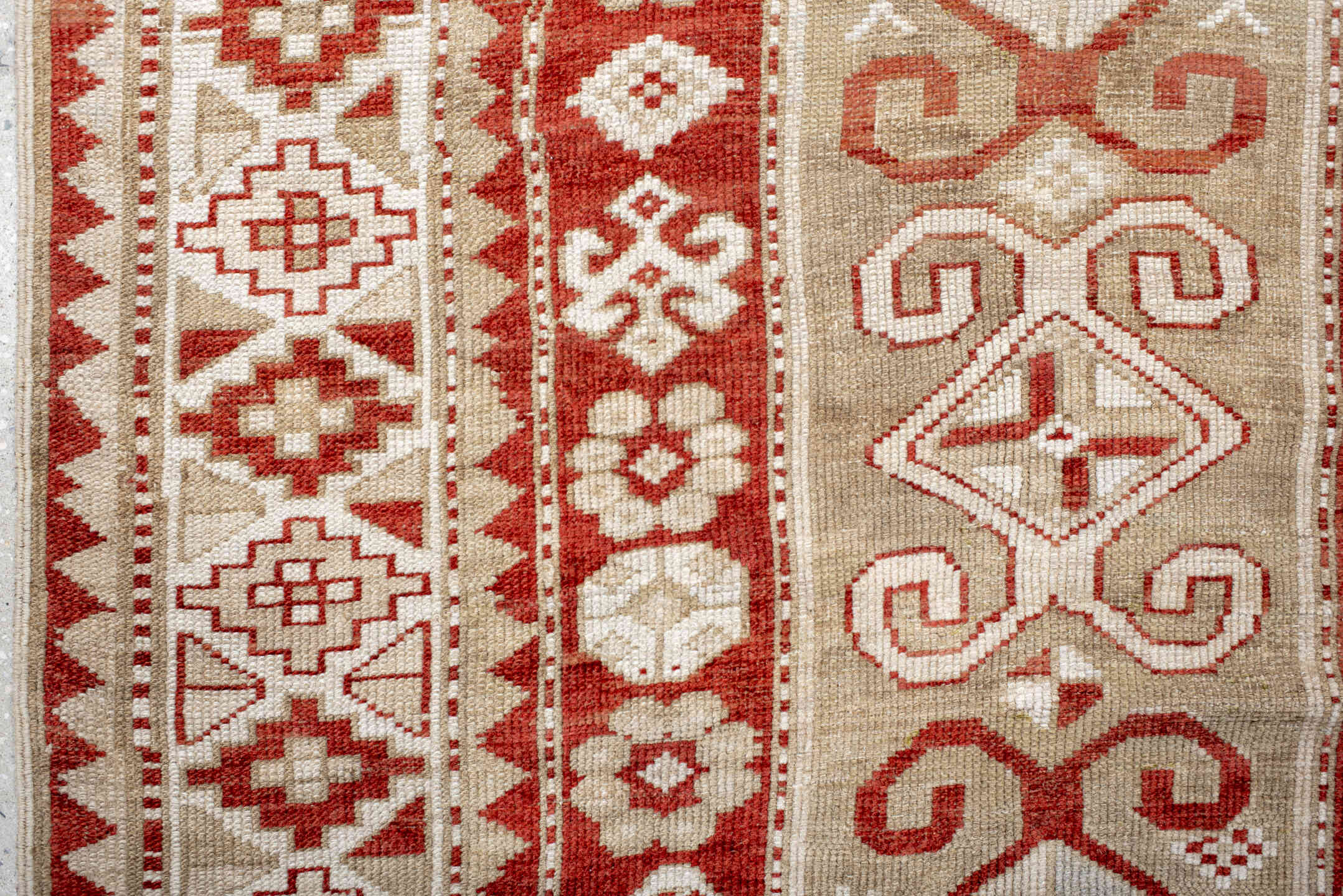4' x 9' one-of-a-kind handmade vintage Caucasian runner rug. Color palette: brown, gray, light gray, off-white, orange, pink