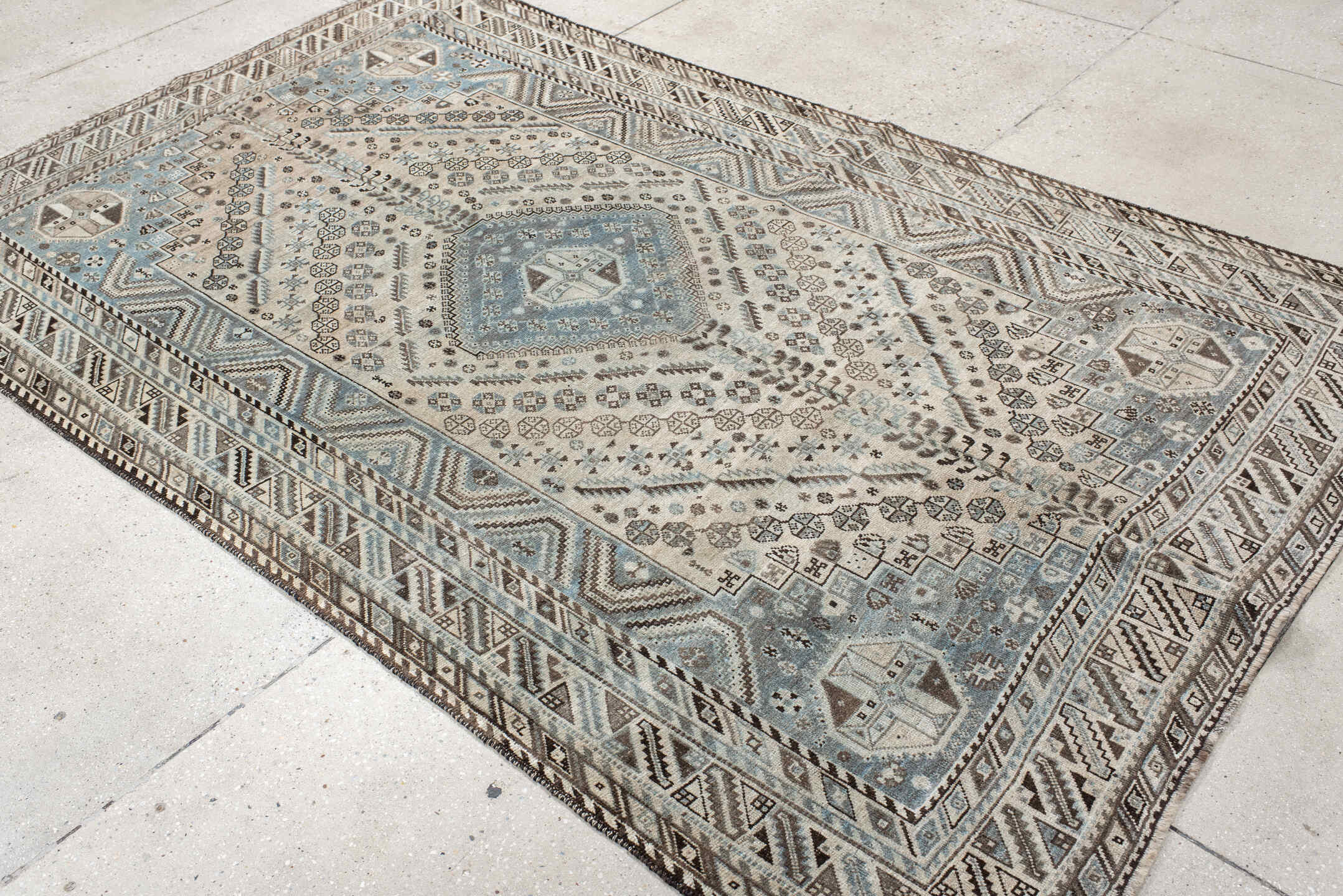 5' x 8' one-of-a-kind handmade antique Shiraz medium size rug. Color palette: ivory, powder blue, brown, charcoal, taupe