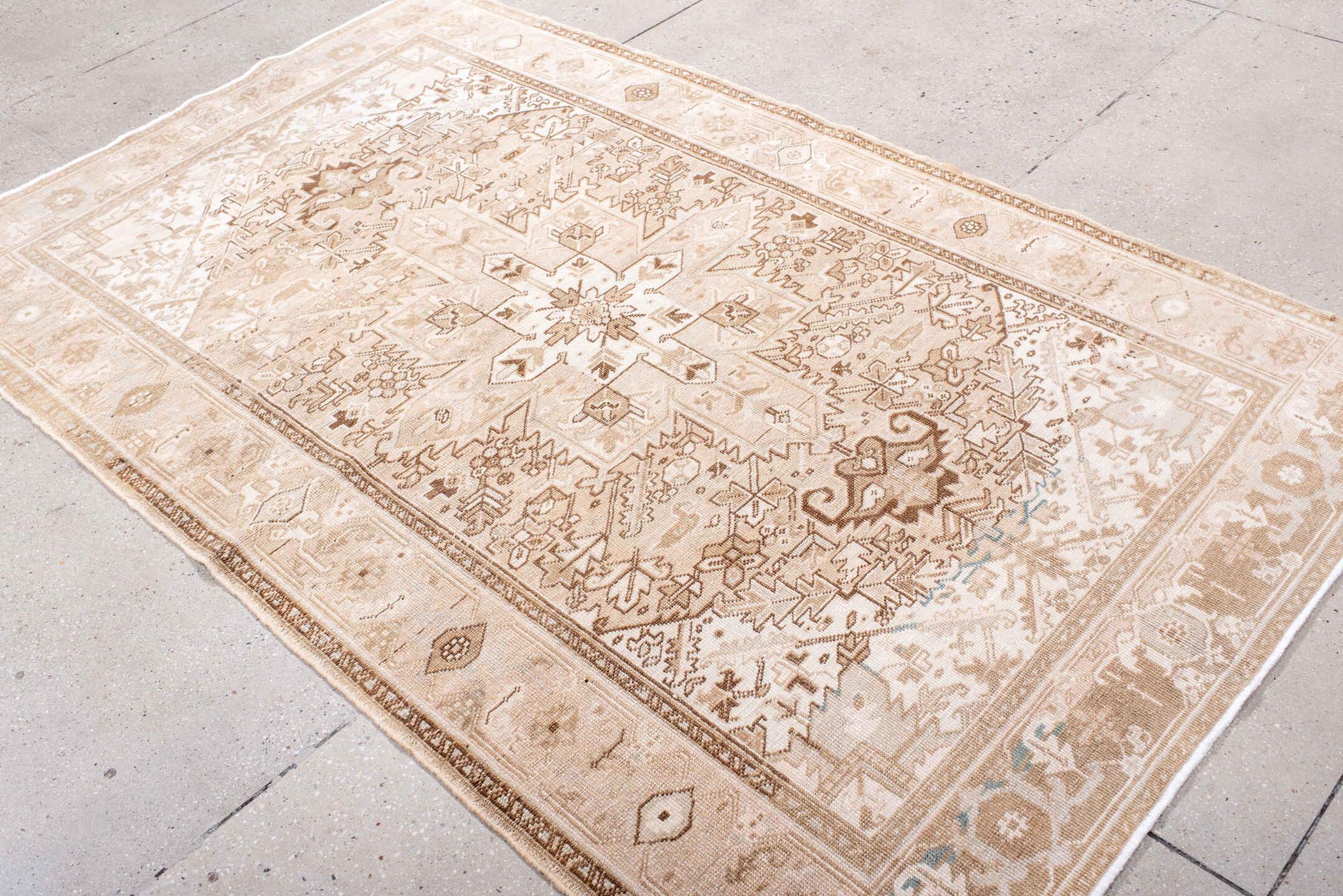 4' x 7' one-of-a-kind handmade antique Heriz rug. Color palette: ivory, blush, camel, taupe, beige, brown, pale blue, pink