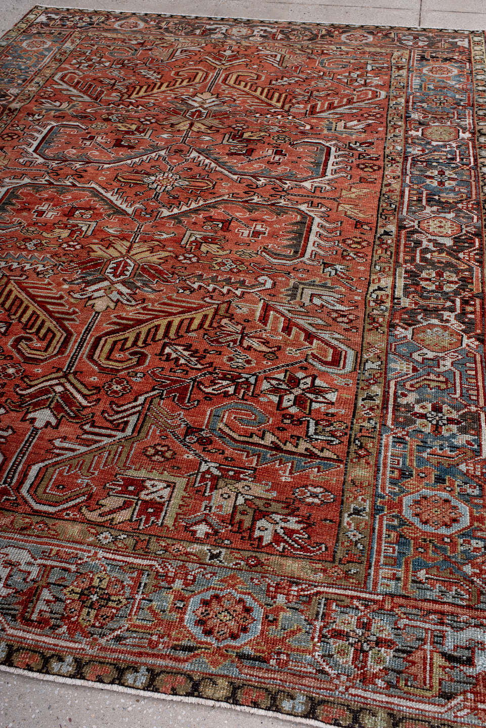 6' x 9' one-of-a-kind handmade antique Heriz rug. Color palette: terra cotta, rust, sky blue, ivory, charcoal, camel