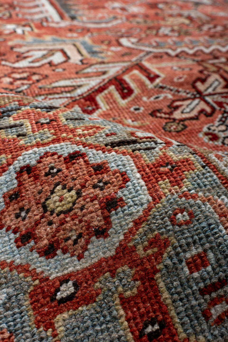 6' x 9' one-of-a-kind handmade antique Heriz rug. Color palette: terra cotta, rust, sky blue, ivory, charcoal, camel