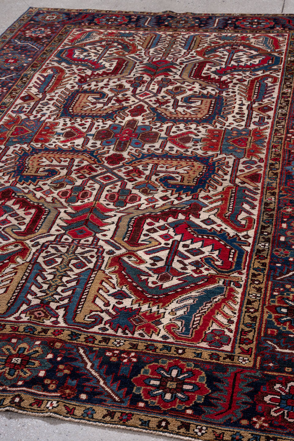 5' x 9' one-of-a-kind handmade vintage Heriz medium size rug. Color palette: ivory, navy, crimson, sky blue, camel, rust