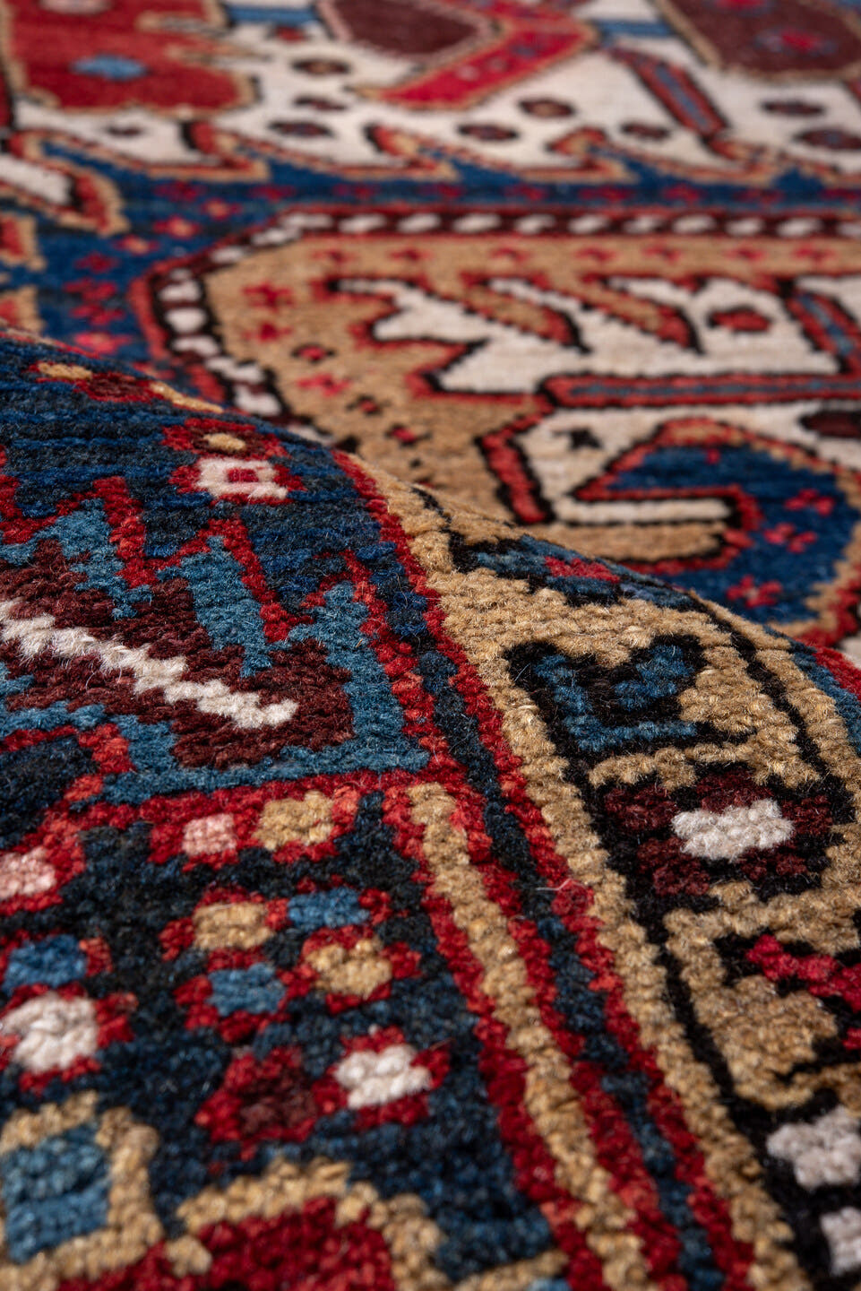 5' x 9' one-of-a-kind handmade vintage Heriz medium size rug. Color palette: ivory, navy, crimson, sky blue, camel, rust