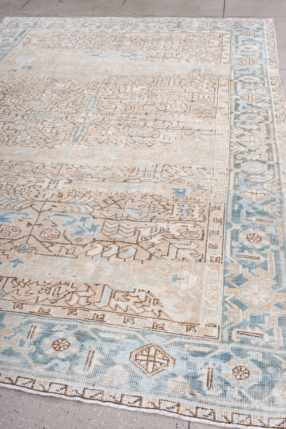 7' x 10' one-of-a-kind handmade antique Heriz large size rug. Color palette: ivory, pale blue, camel, light brown, taupe