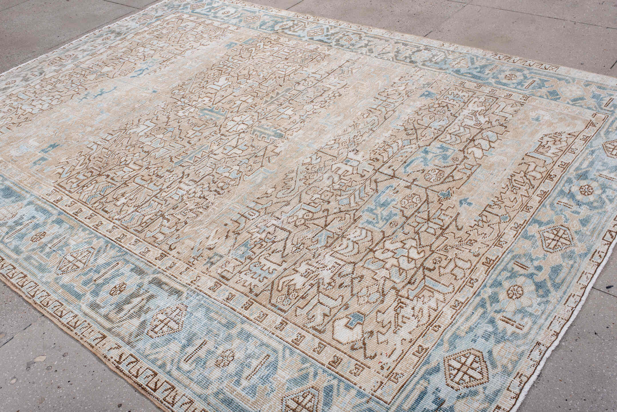 7' x 10' one-of-a-kind handmade antique Heriz large size rug. Color palette: ivory, pale blue, camel, light brown, taupe