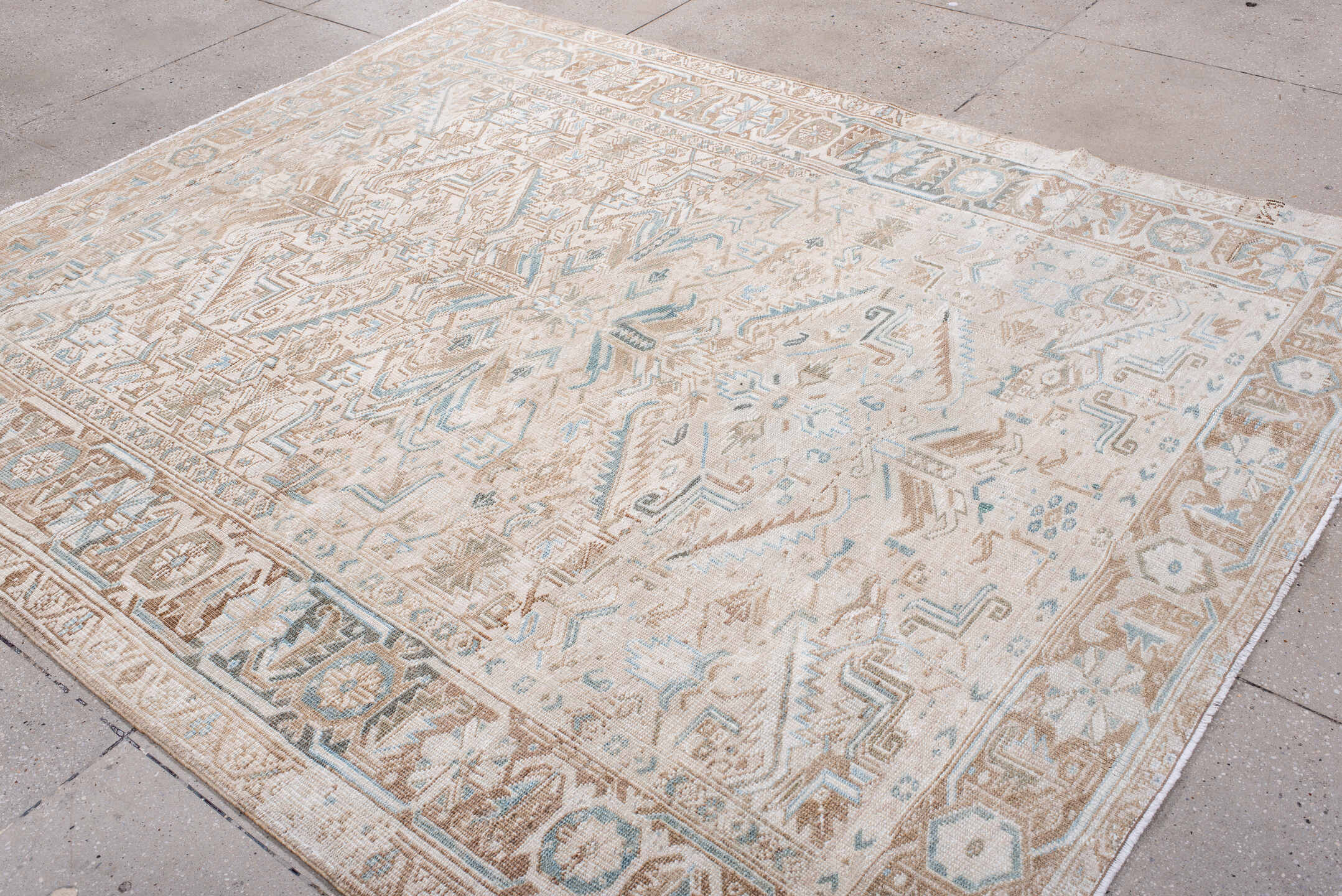 7' x 8' one-of-a-kind handmade antique Heriz rug. Color palette: ivory, camel, pale blue, taupe, beige, light brown