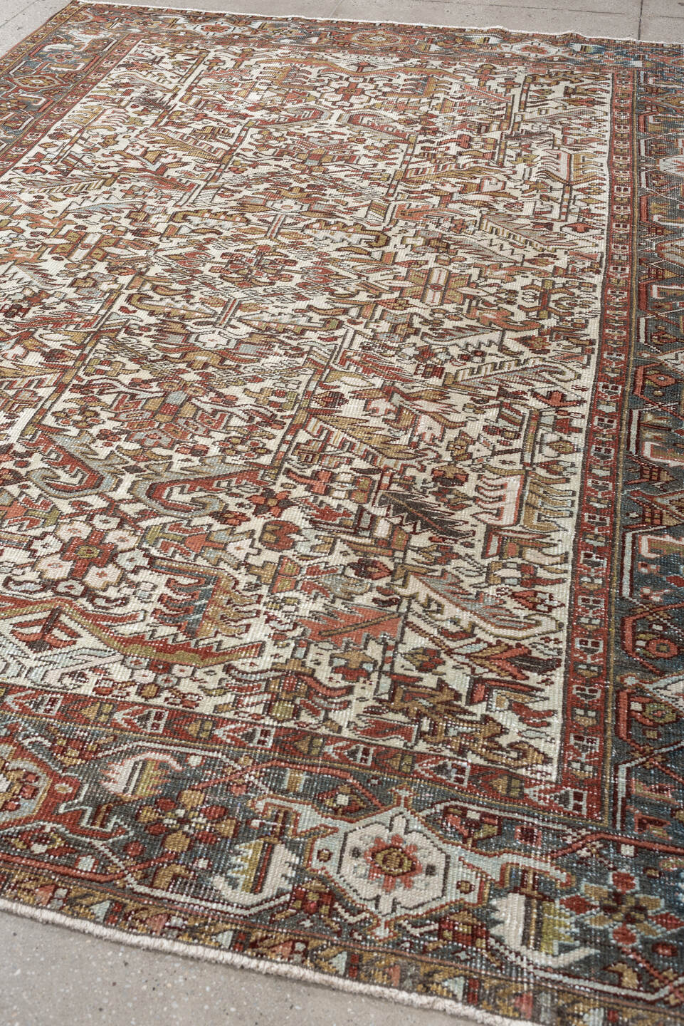 7' x 9' one-of-a-kind handmade vintage Heriz rug. Color palette: ivory, blue gray, rust, camel, sage, terracotta, taupe