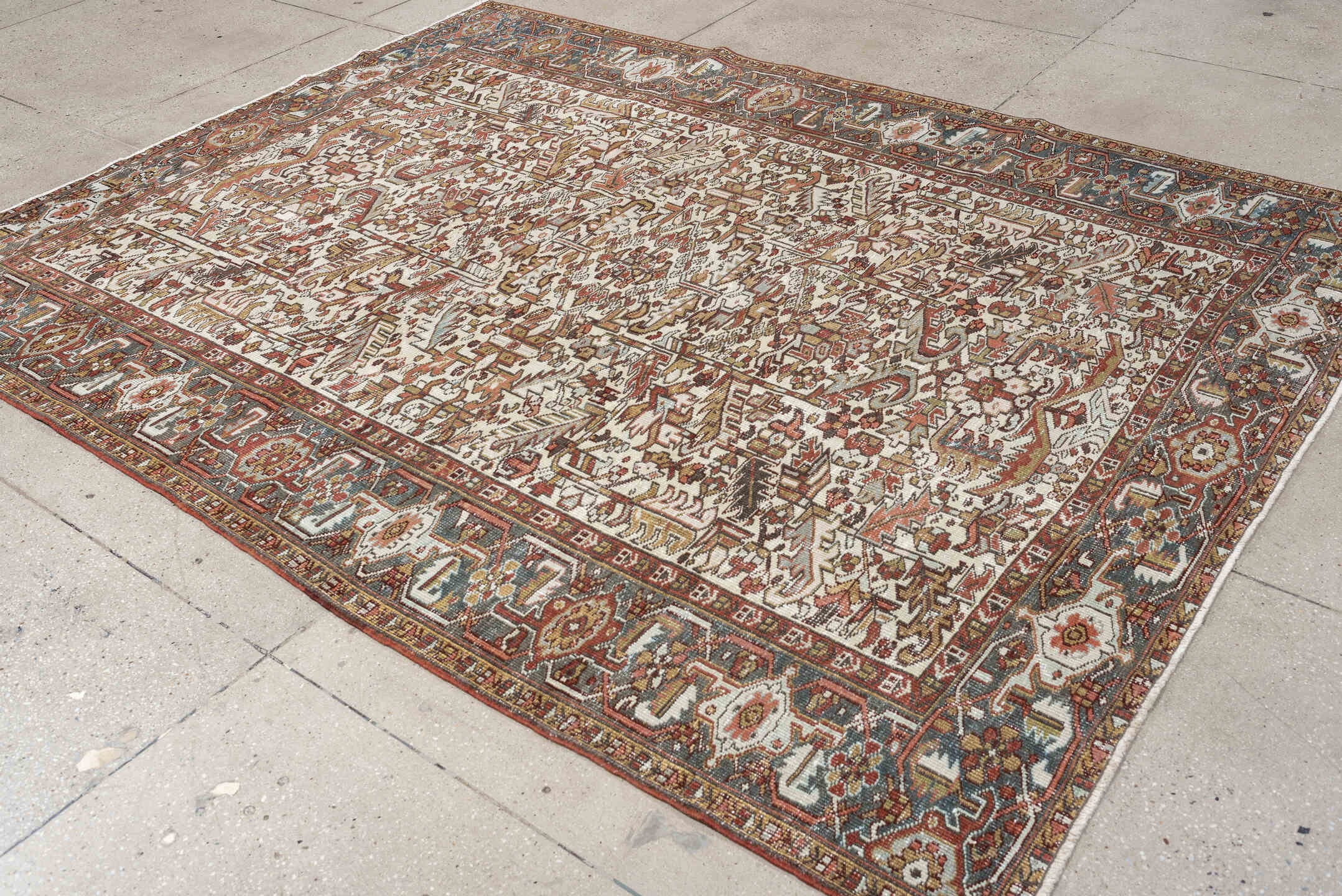 7' x 9' one-of-a-kind handmade vintage Heriz rug. Color palette: ivory, blue gray, rust, camel, sage, terracotta, taupe