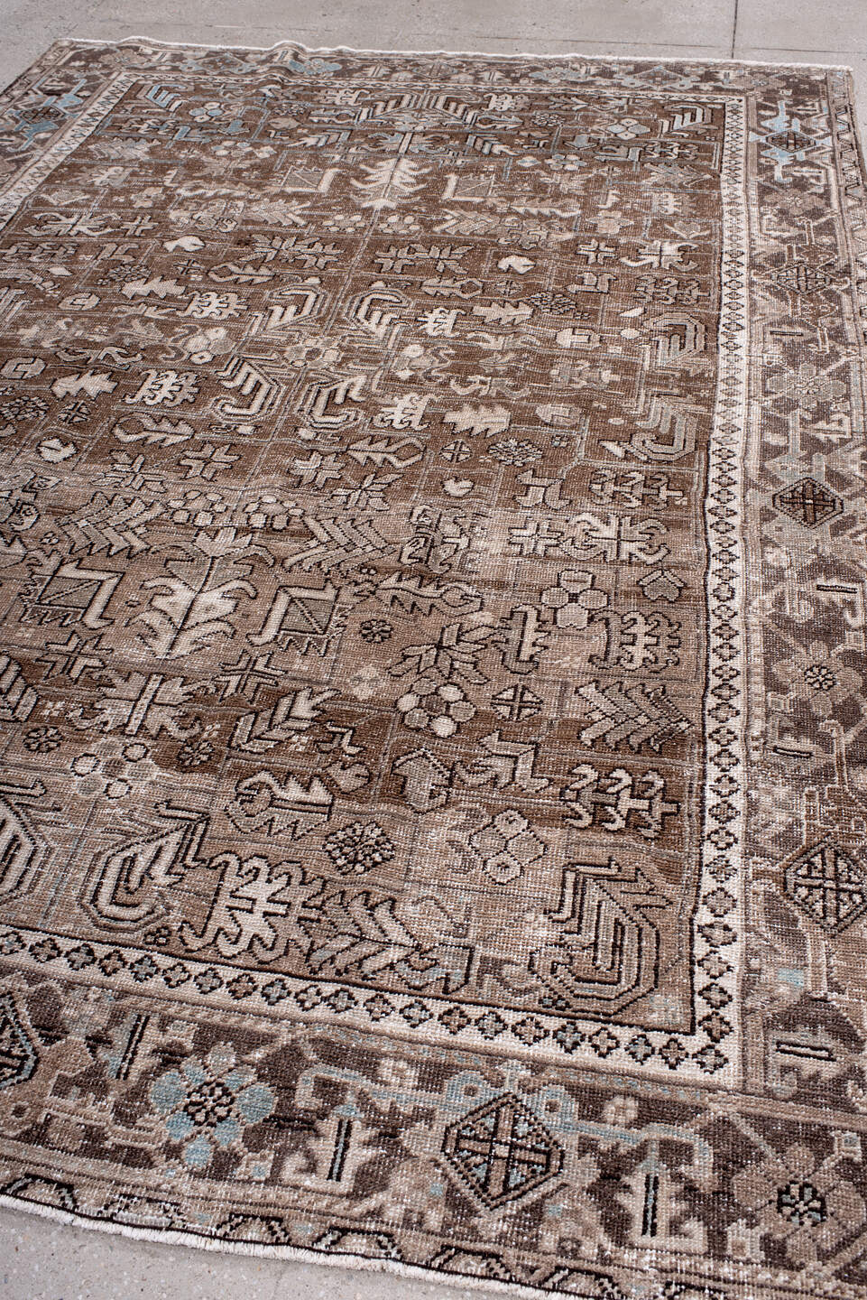 7' x 10' one-of-a-kind handmade antique Heriz large size rug. Color palette: brown, taupe, ivory, camel, slate, pale blue