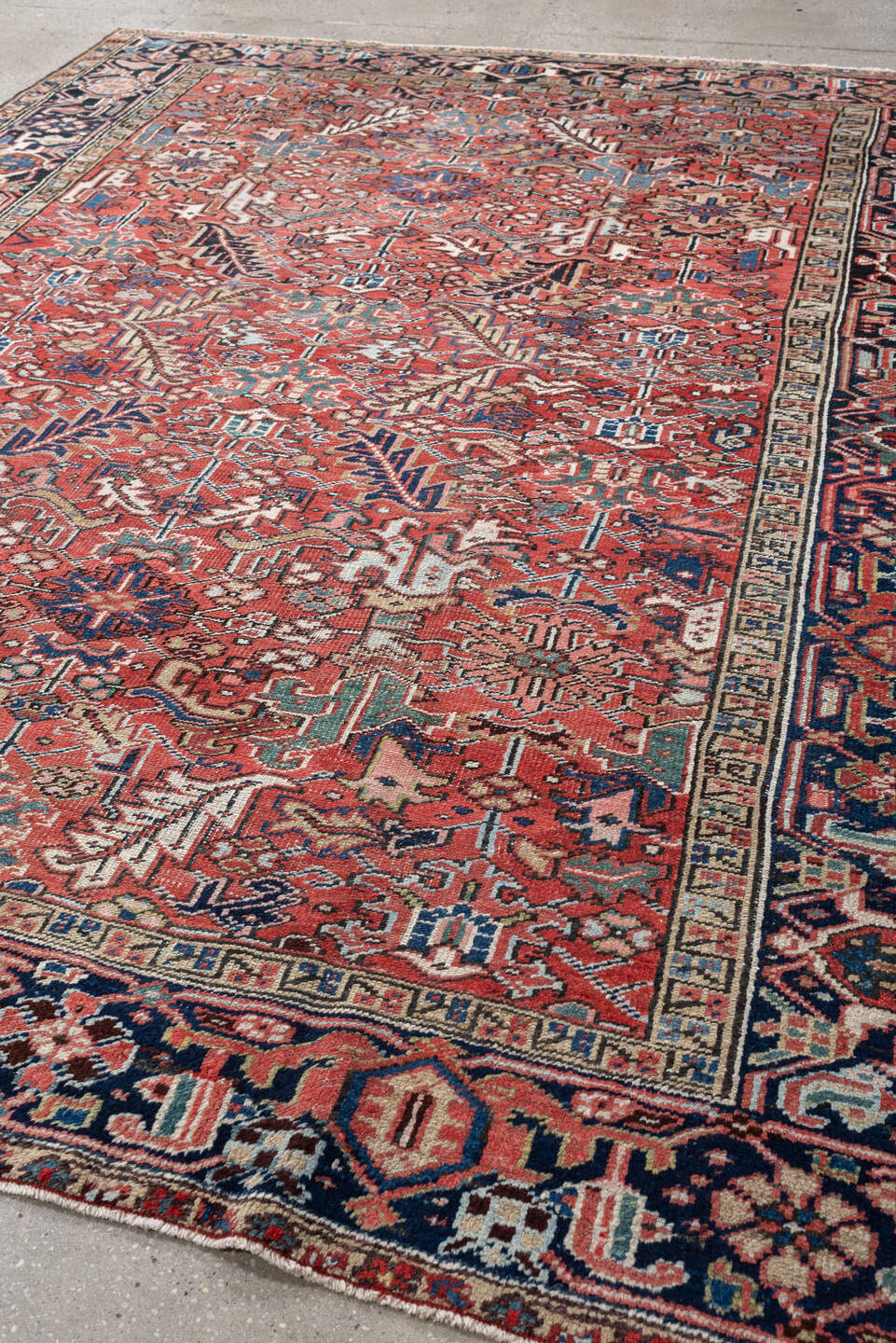 7' x 9' one-of-a-kind handmade vintage Heriz rug. Color palette: terracotta, navy, ivory, sky blue, slate blue, coral, camel