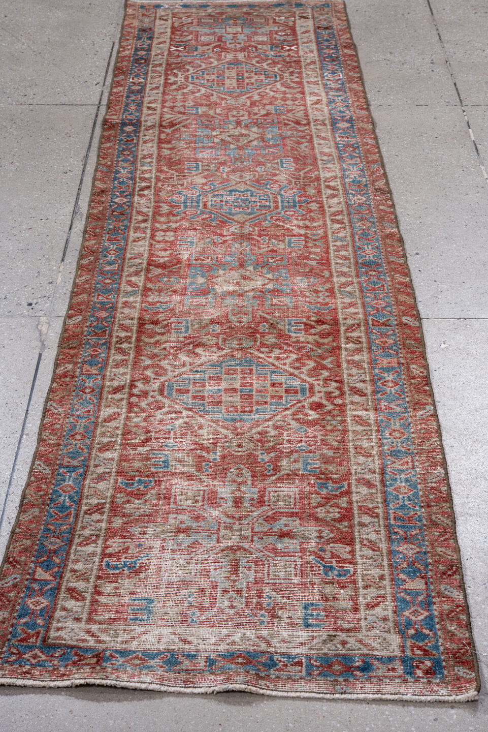 2' x 8' one-of-a-kind handmade vintage Karaje runner rug. Color palette: rust, ivory, sky blue, brick, coral, slate blue