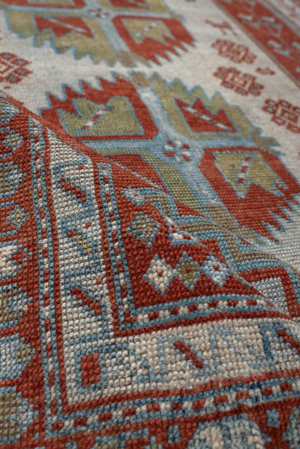 4' x 3' one-of-a-kind handmade antique Caucasian rug. Color palette: terracotta, sky blue, ivory, sage, rust, brown