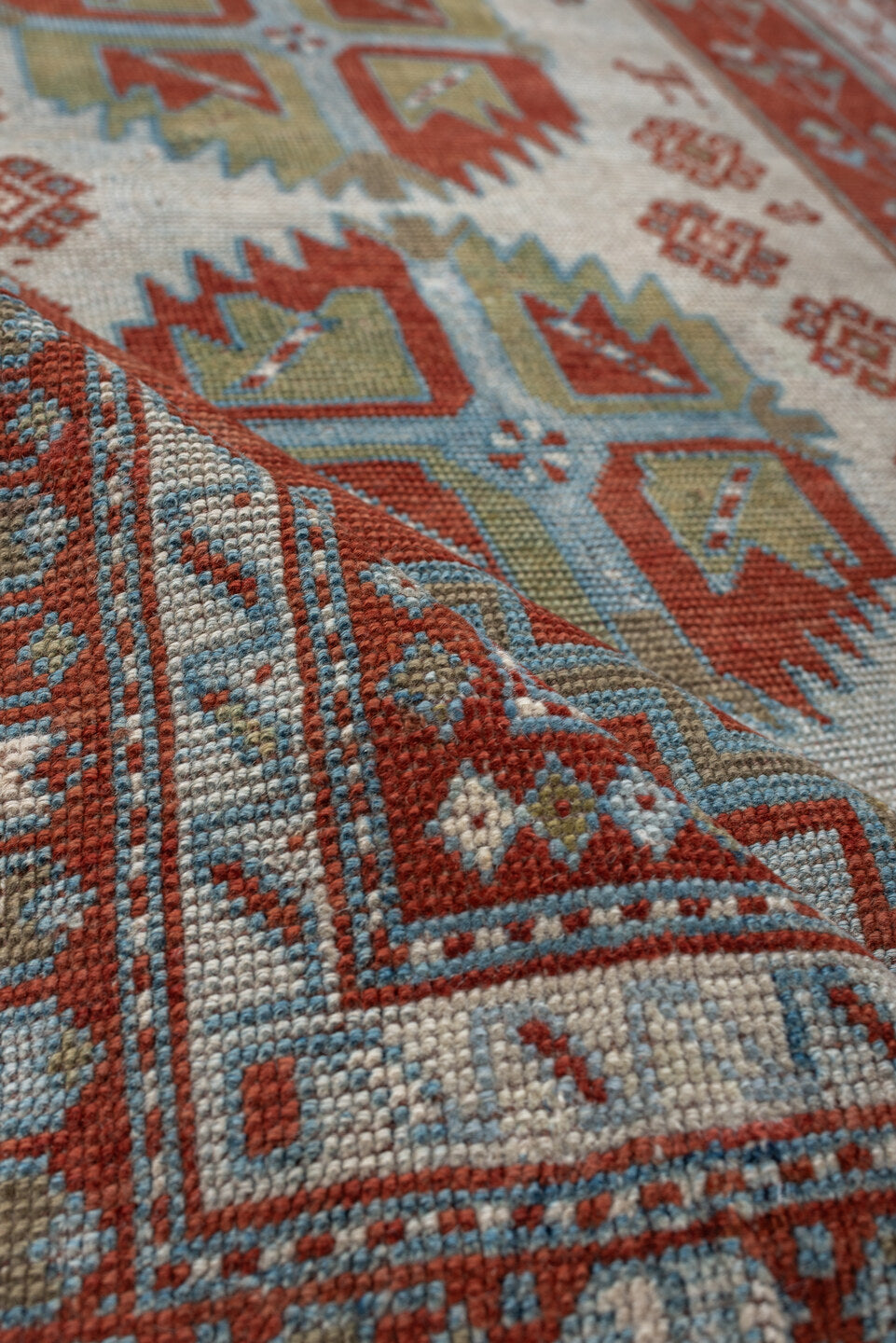 4' x 3' one-of-a-kind handmade antique Caucasian rug. Color palette: terracotta, sky blue, ivory, sage, rust, brown