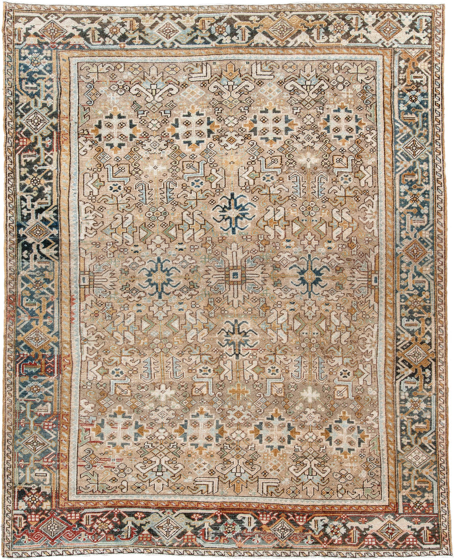 7' x 9' one-of-a-kind handmade antique Heriz rug. Color palette: taupe, ivory, faded indigo, camel, rust, charcoal, beige