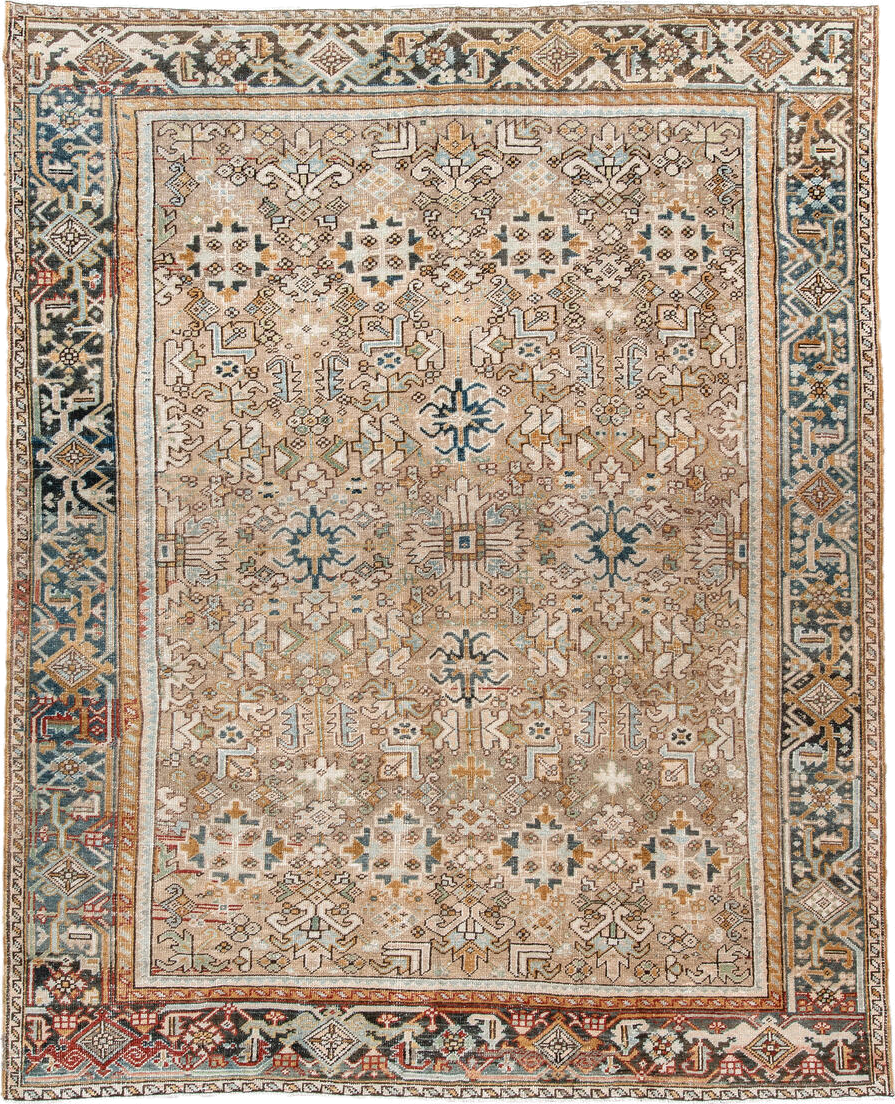 7' x 9' one-of-a-kind handmade antique Heriz rug. Color palette: taupe, ivory, faded indigo, camel, rust, charcoal, beige