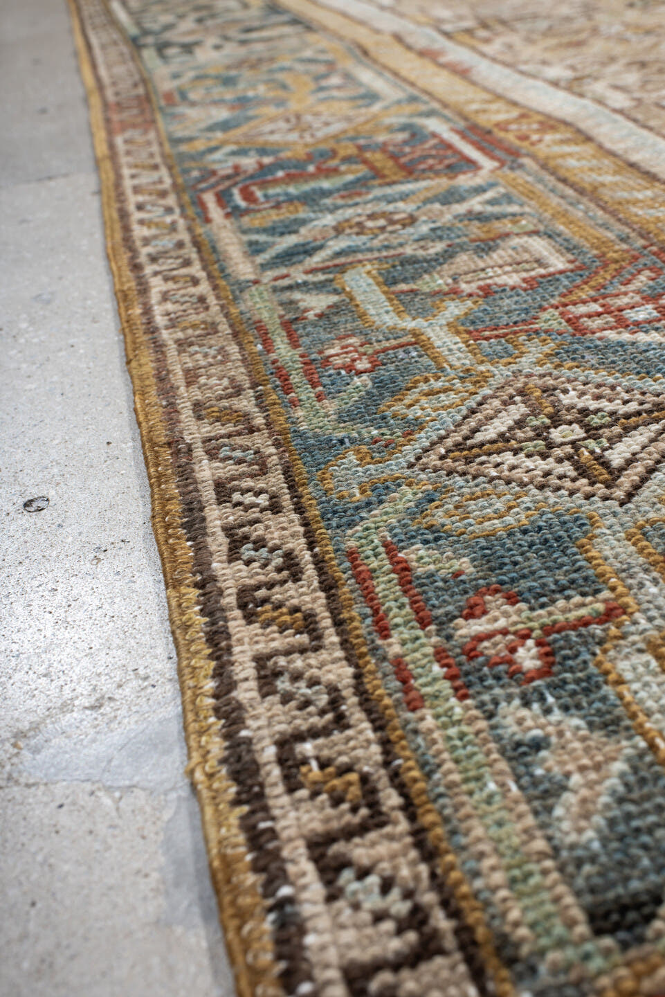 7' x 9' one-of-a-kind handmade antique Heriz rug. Color palette: taupe, ivory, faded indigo, camel, rust, charcoal, beige