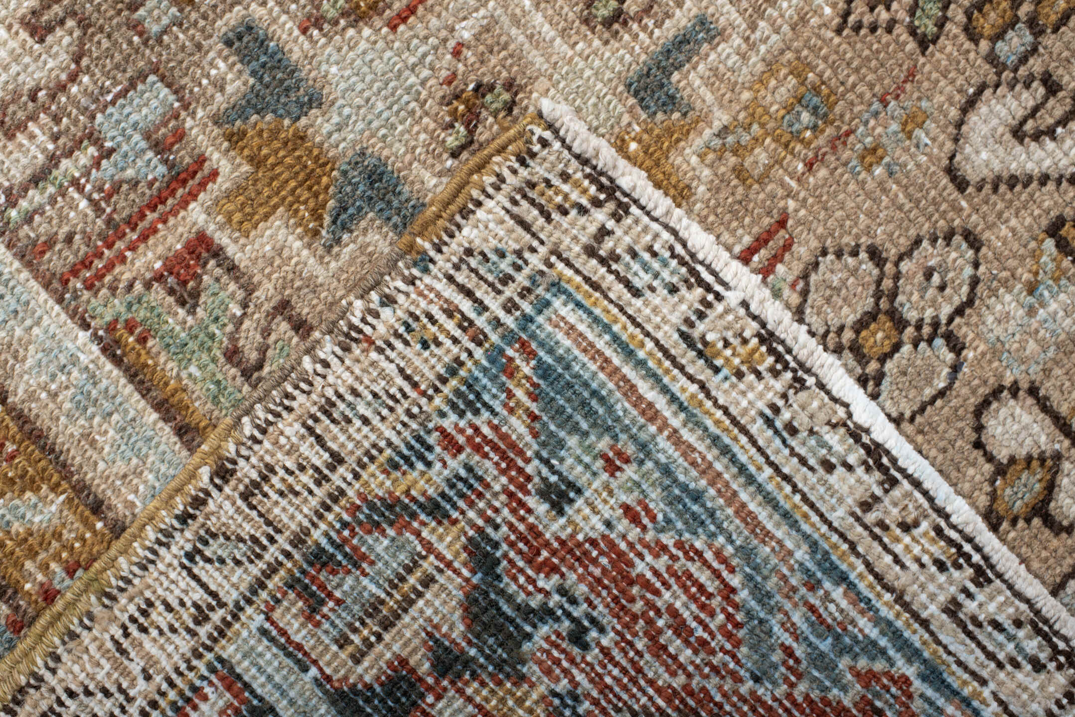 7' x 9' one-of-a-kind handmade antique Heriz rug. Color palette: taupe, ivory, faded indigo, camel, rust, charcoal, beige