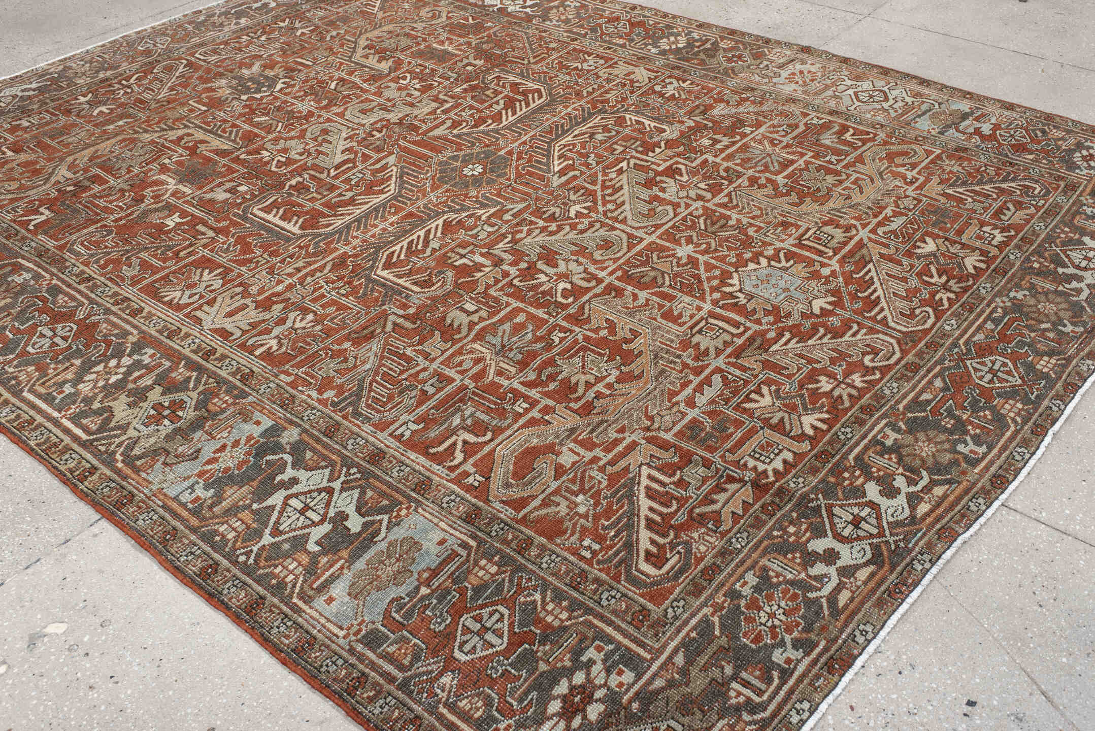8' x 9' one-of-a-kind handmade antique Heriz rug. Color palette: terra cotta, ivory, taupe, brown, charcoal, rust