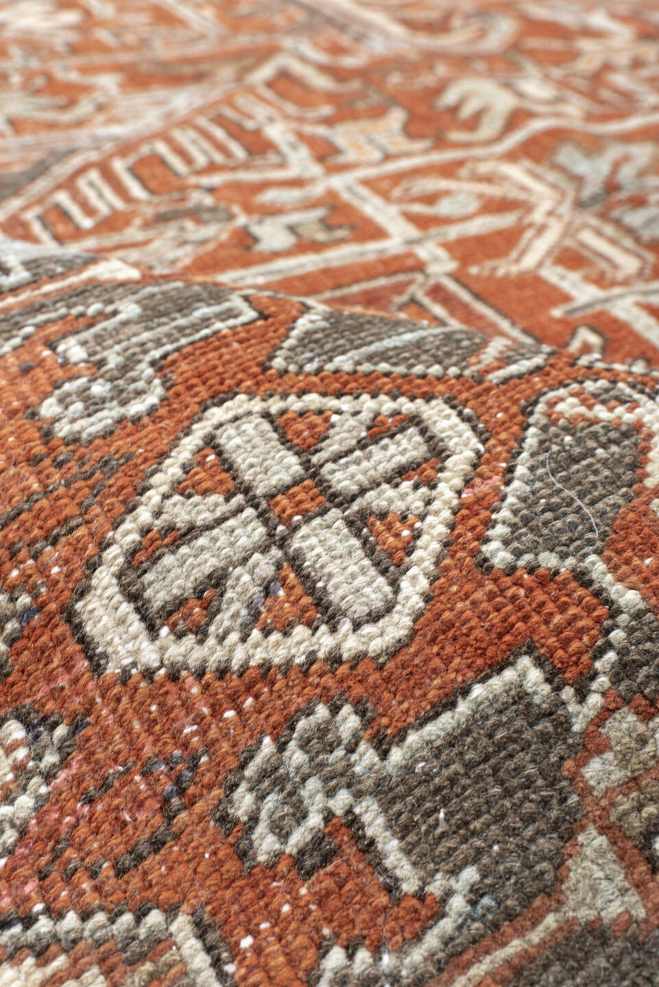 8' x 9' one-of-a-kind handmade antique Heriz rug. Color palette: terra cotta, ivory, taupe, brown, charcoal, rust