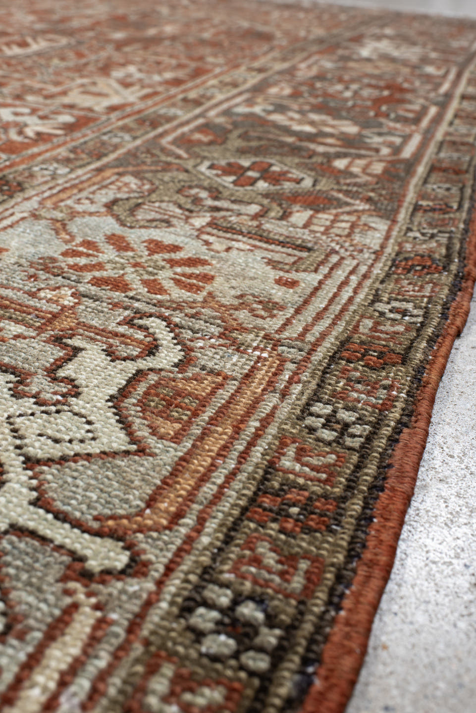 8' x 9' one-of-a-kind handmade antique Heriz rug. Color palette: terra cotta, ivory, taupe, brown, charcoal, rust