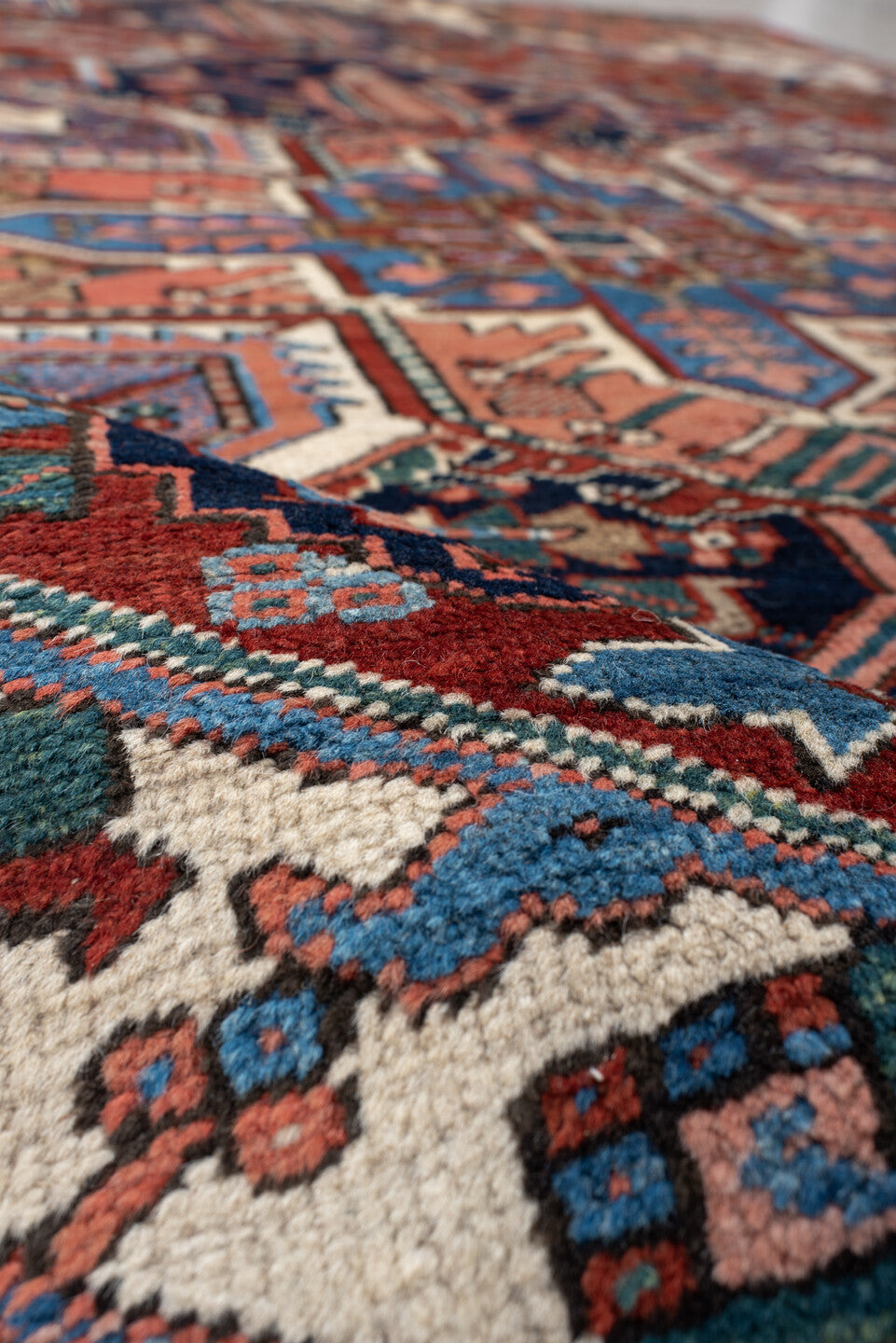 6' x 9' one-of-a-kind handmade vintage Heriz medium size rug. Color palette: rust, ivory, navy, sky blue, coral, teal, sage