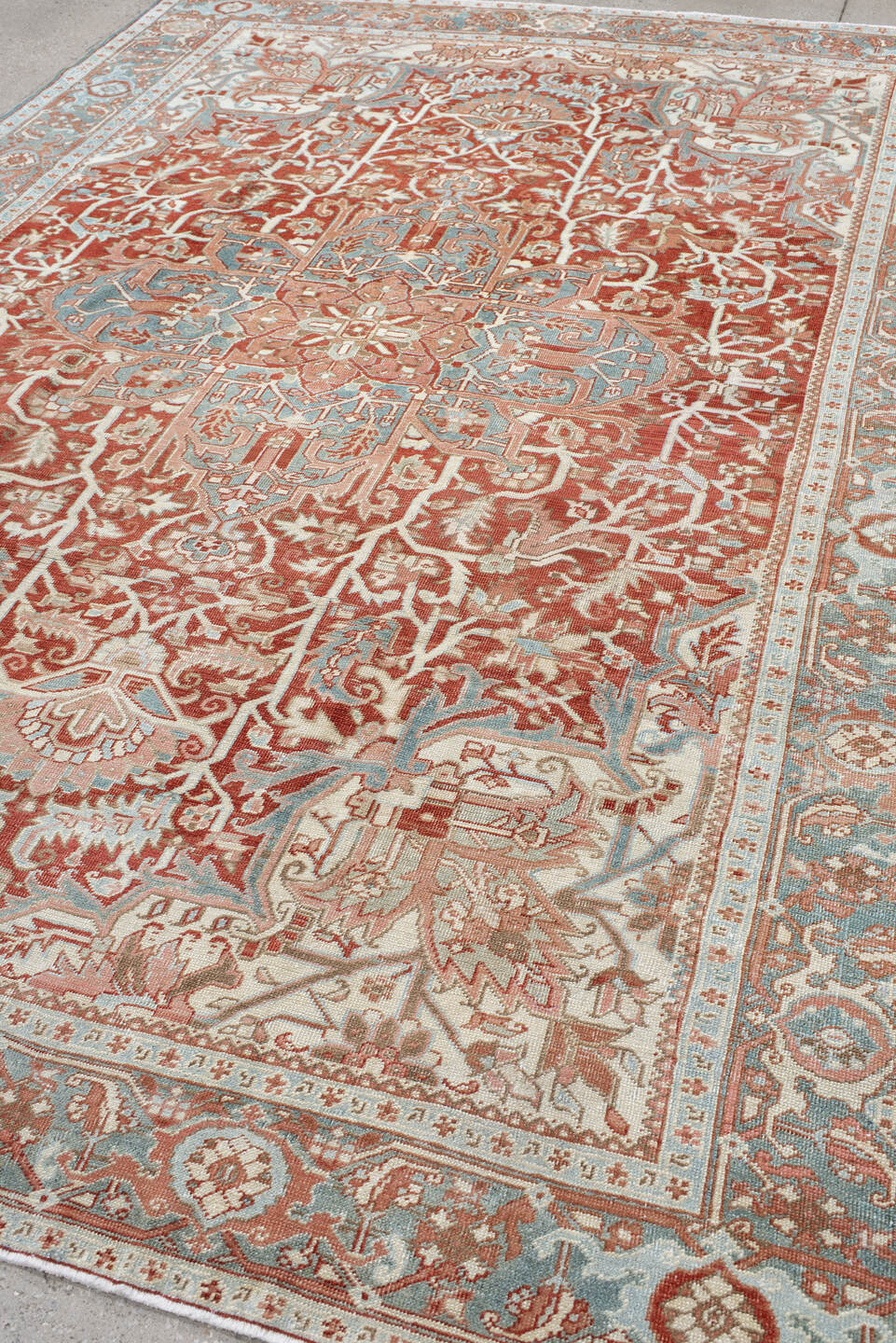 7' x 10' one-of-a-kind handmade antique Heriz large size rug. Color palette: rust, ivory, pale blue, terra cotta, sage