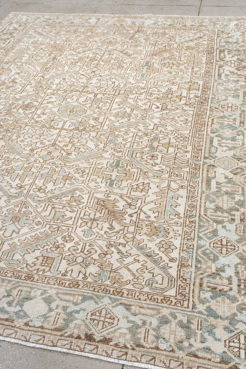 7' x 9' one-of-a-kind handmade antique Heriz rug. Color palette: ivory, camel, pale blue, taupe, beige, light gray