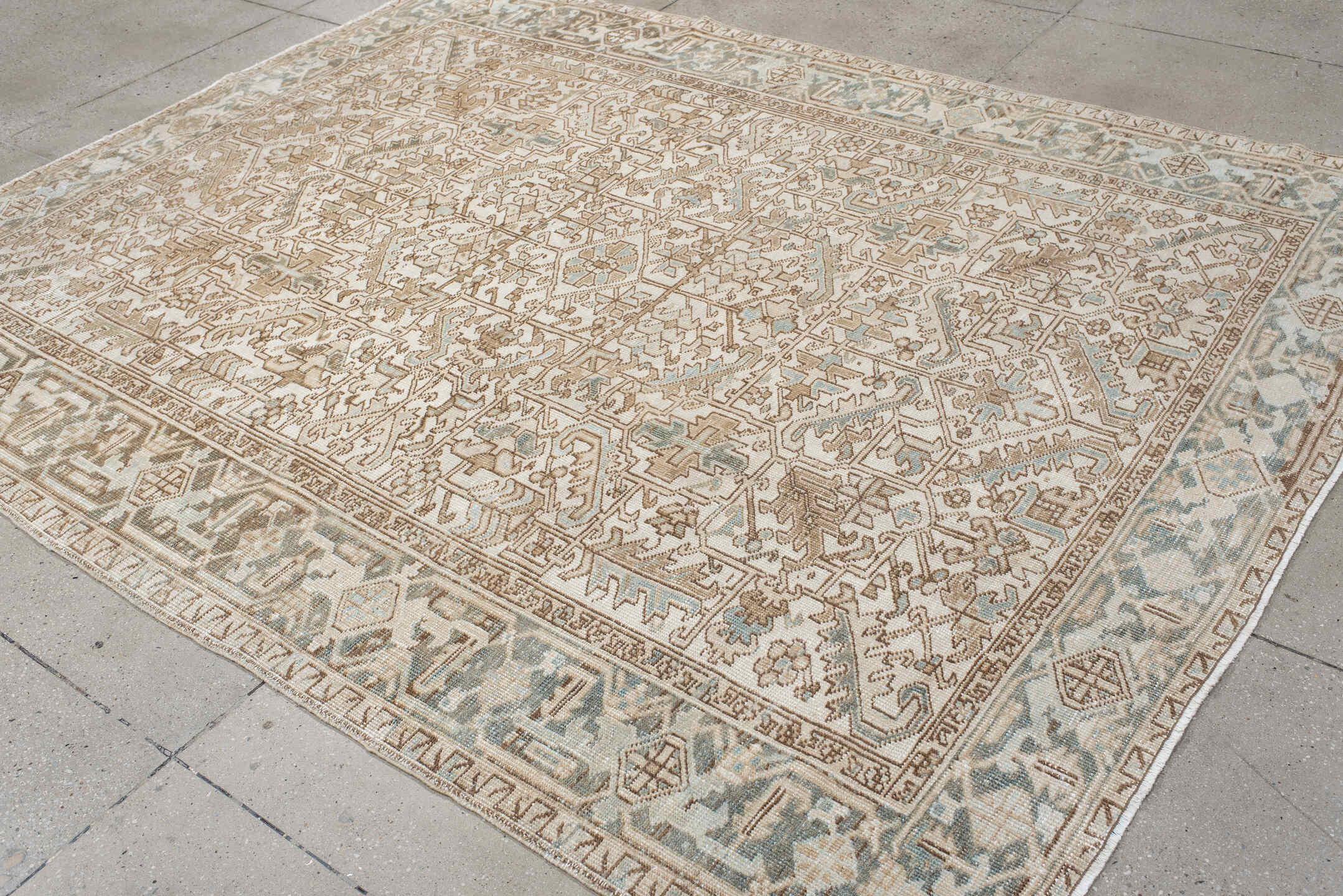 7' x 9' one-of-a-kind handmade antique Heriz rug. Color palette: ivory, camel, pale blue, taupe, beige, light gray
